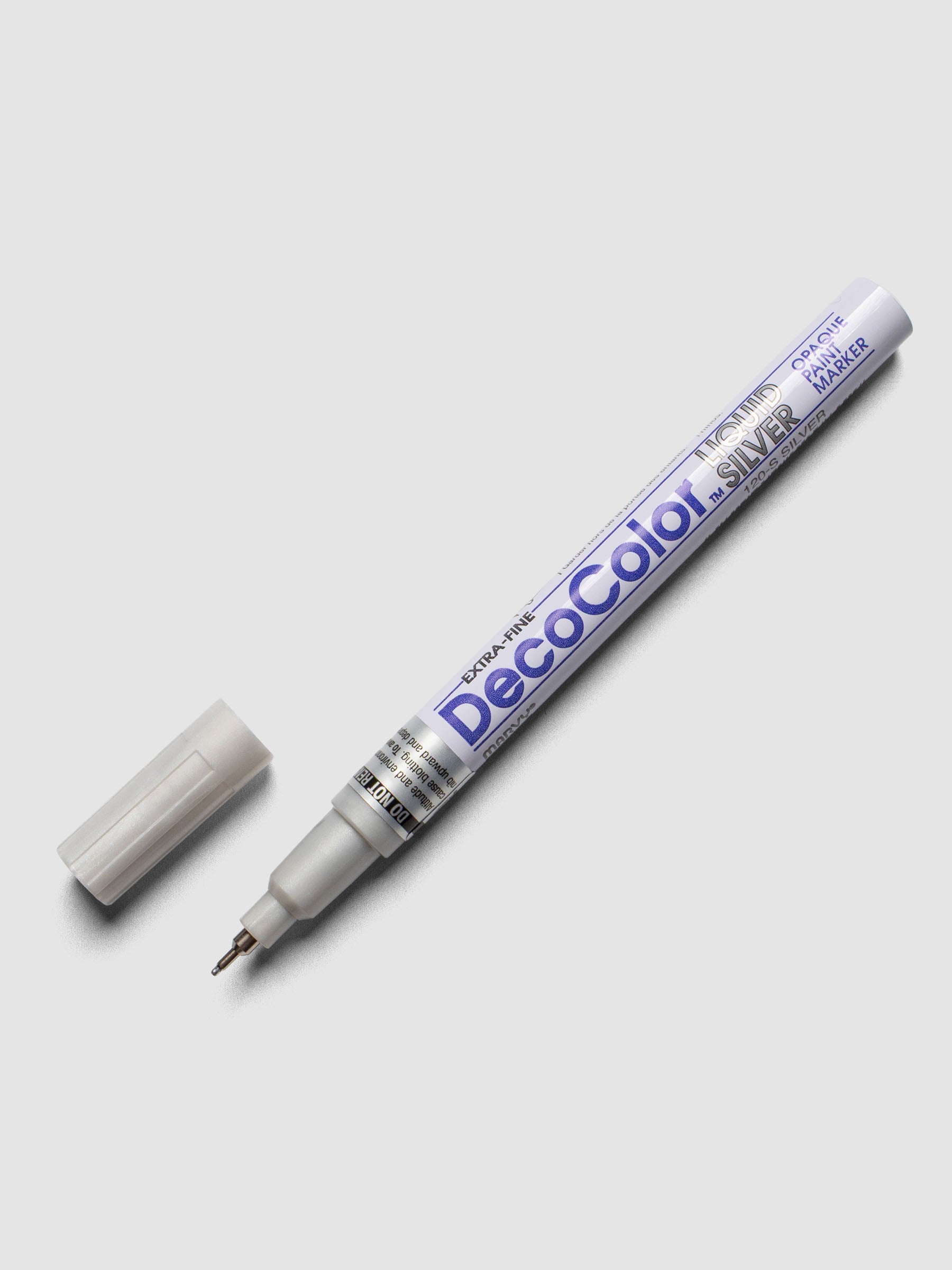 Silver DecoColor paint marker in extra fine shown with cap removed.
