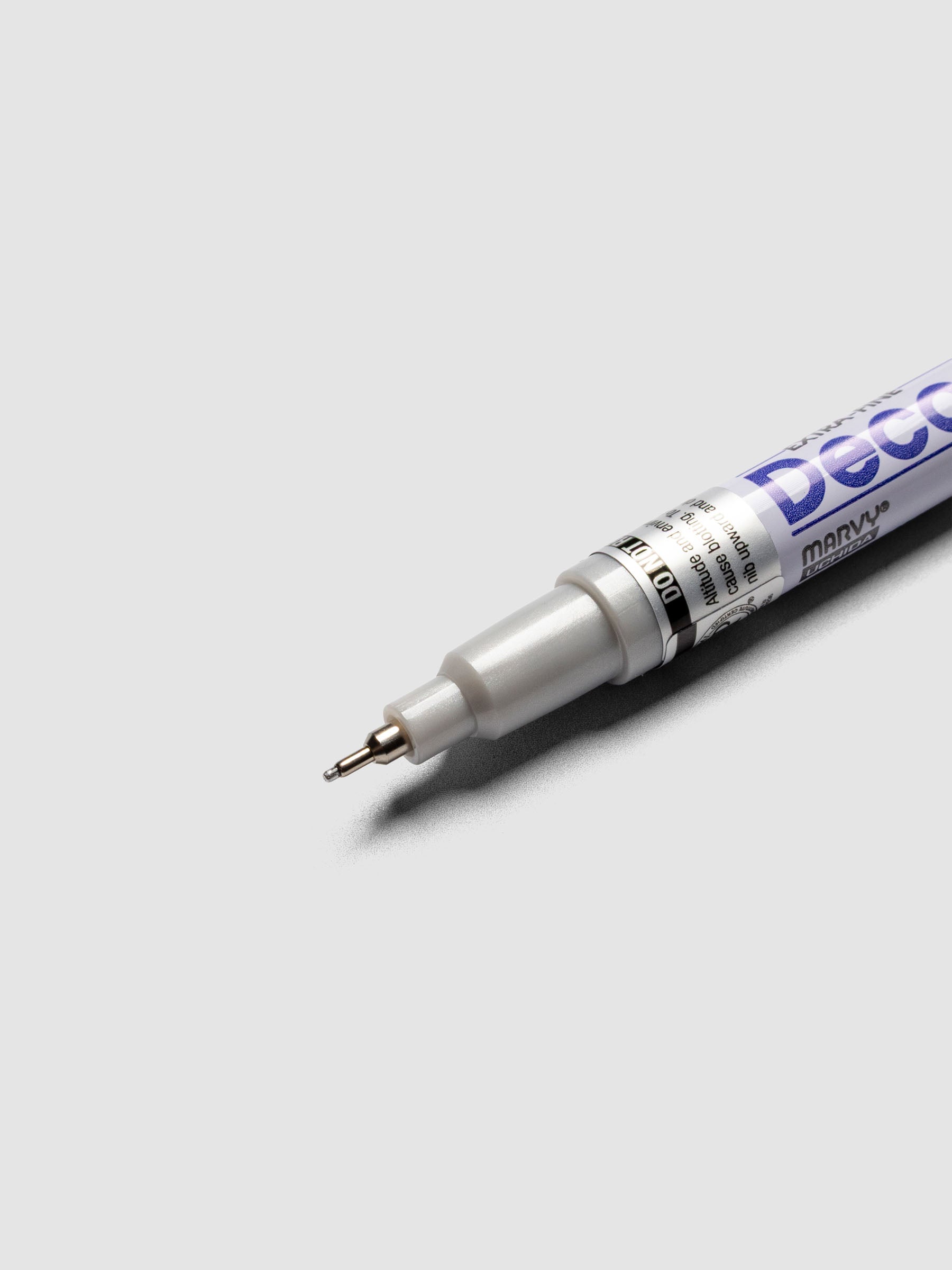 Close up of the Silver DecoColor paint marker in extra fine showing the nib