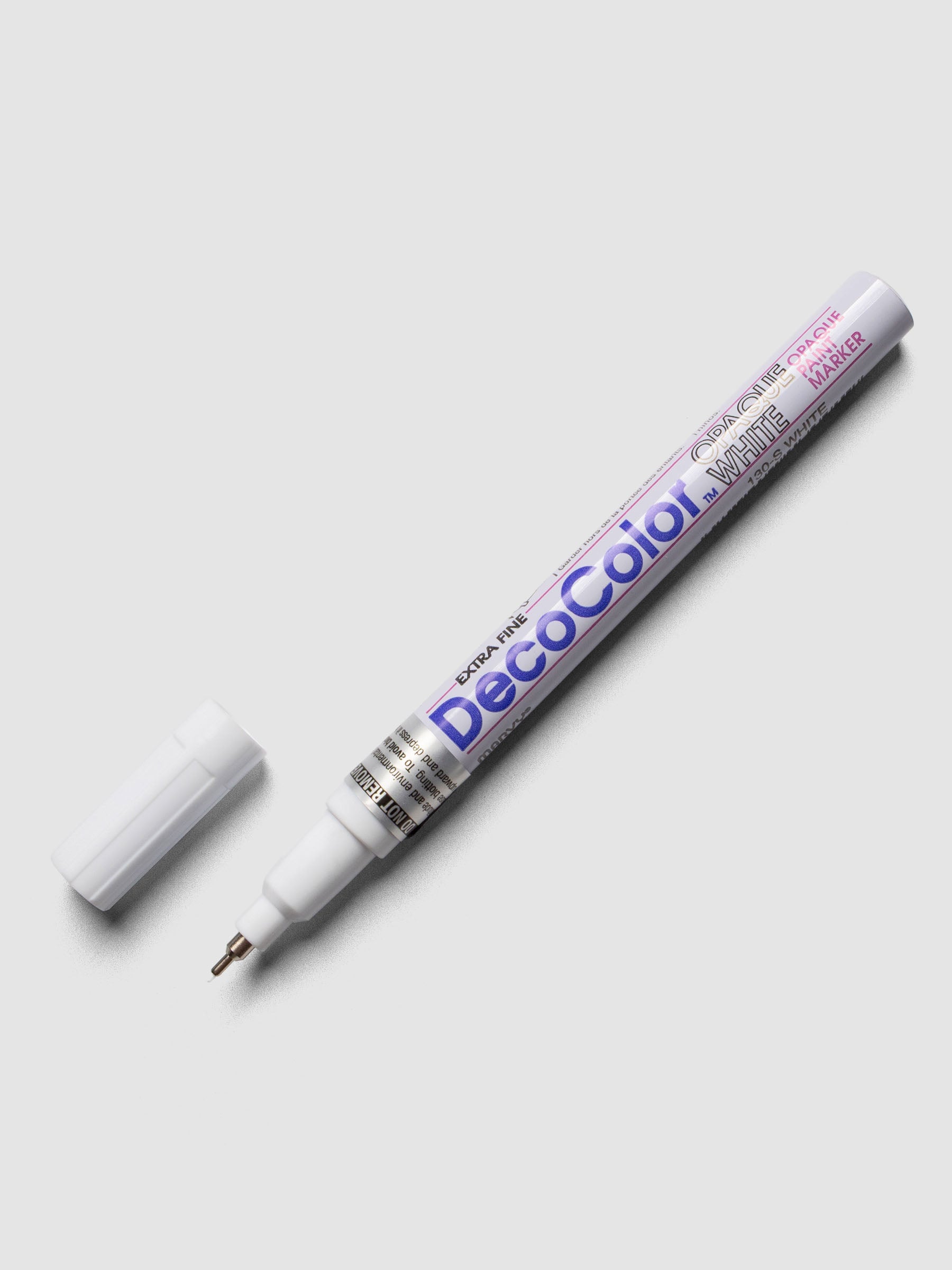 White DecoColor paint marker in extra fine shown with cap removed.