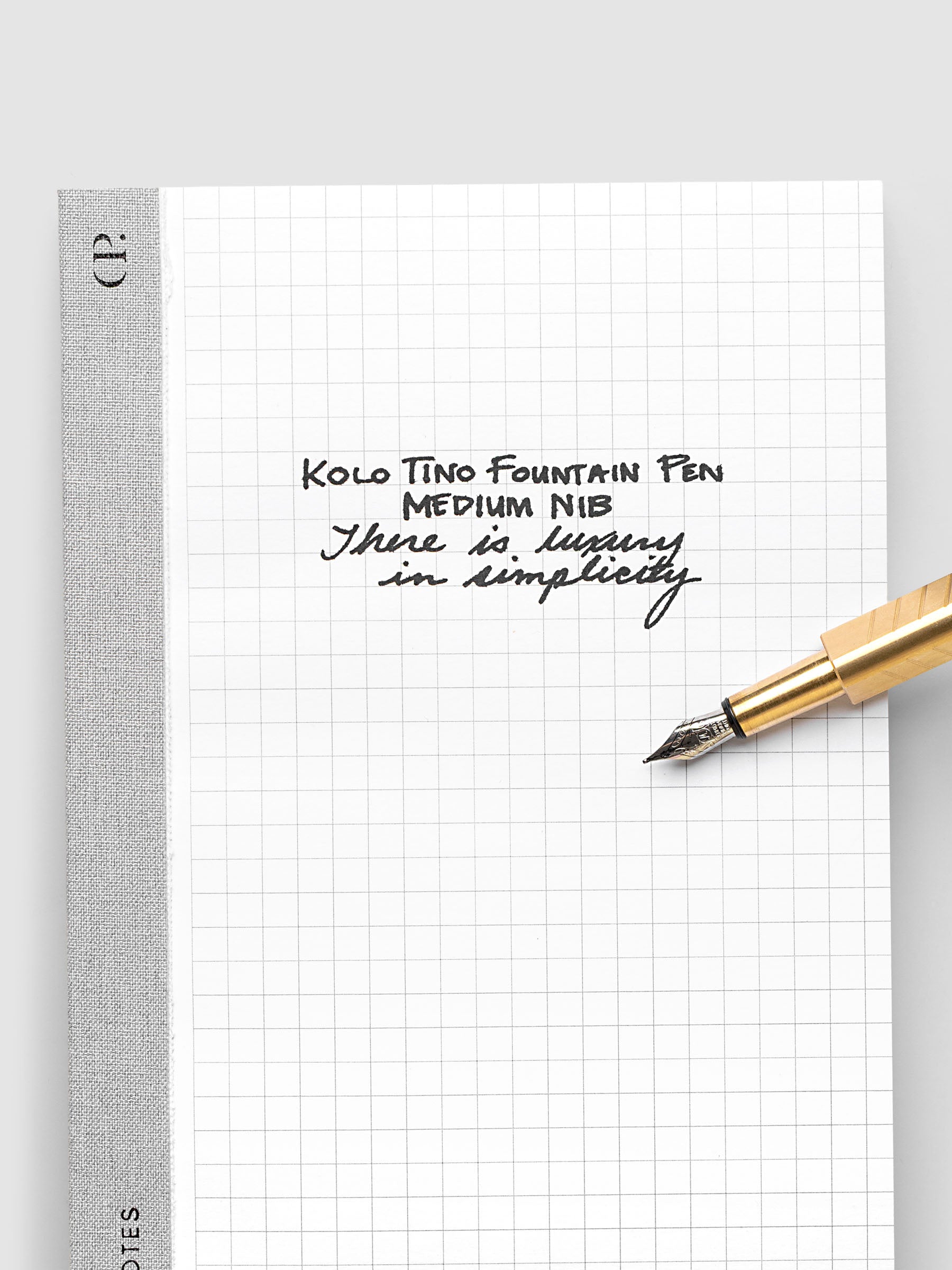 Kolo Tino Fountain Pen writing sample with medium nib and included cartridge on a blank piece of graph paper.
