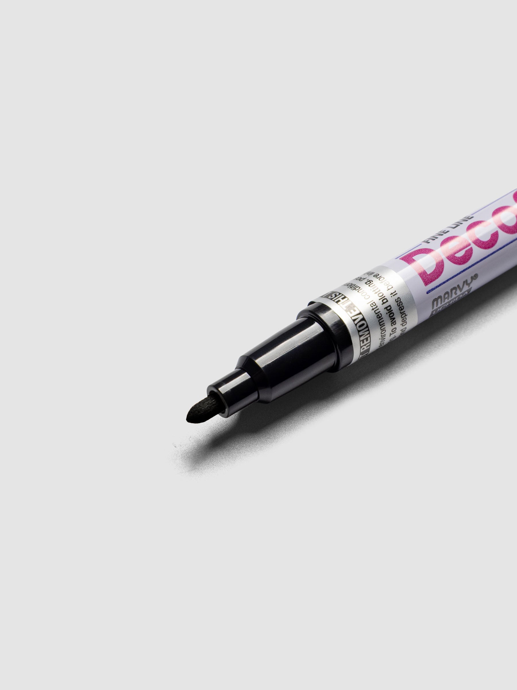 Close up of the Black DecoColor paint marker in fine showing the nib