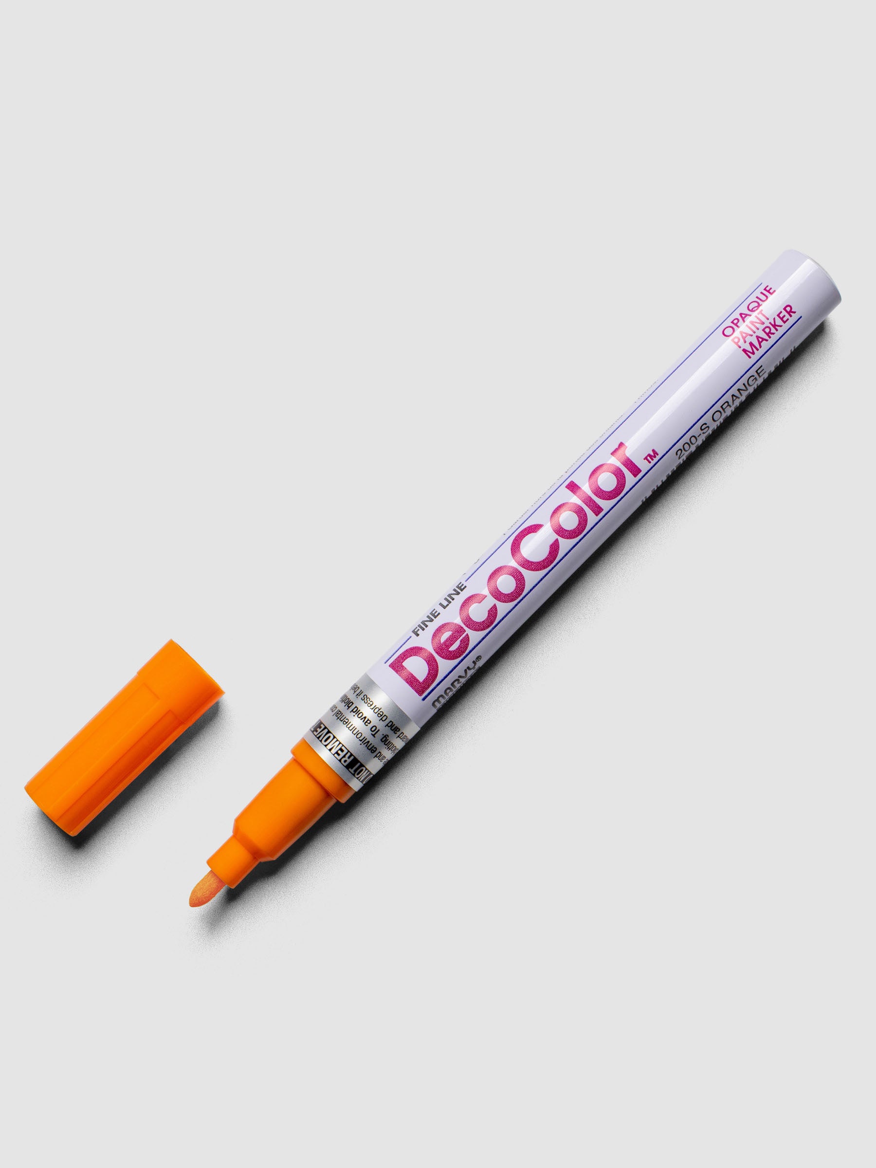 Orange DecoColor paint marker in fine shown with cap removed.