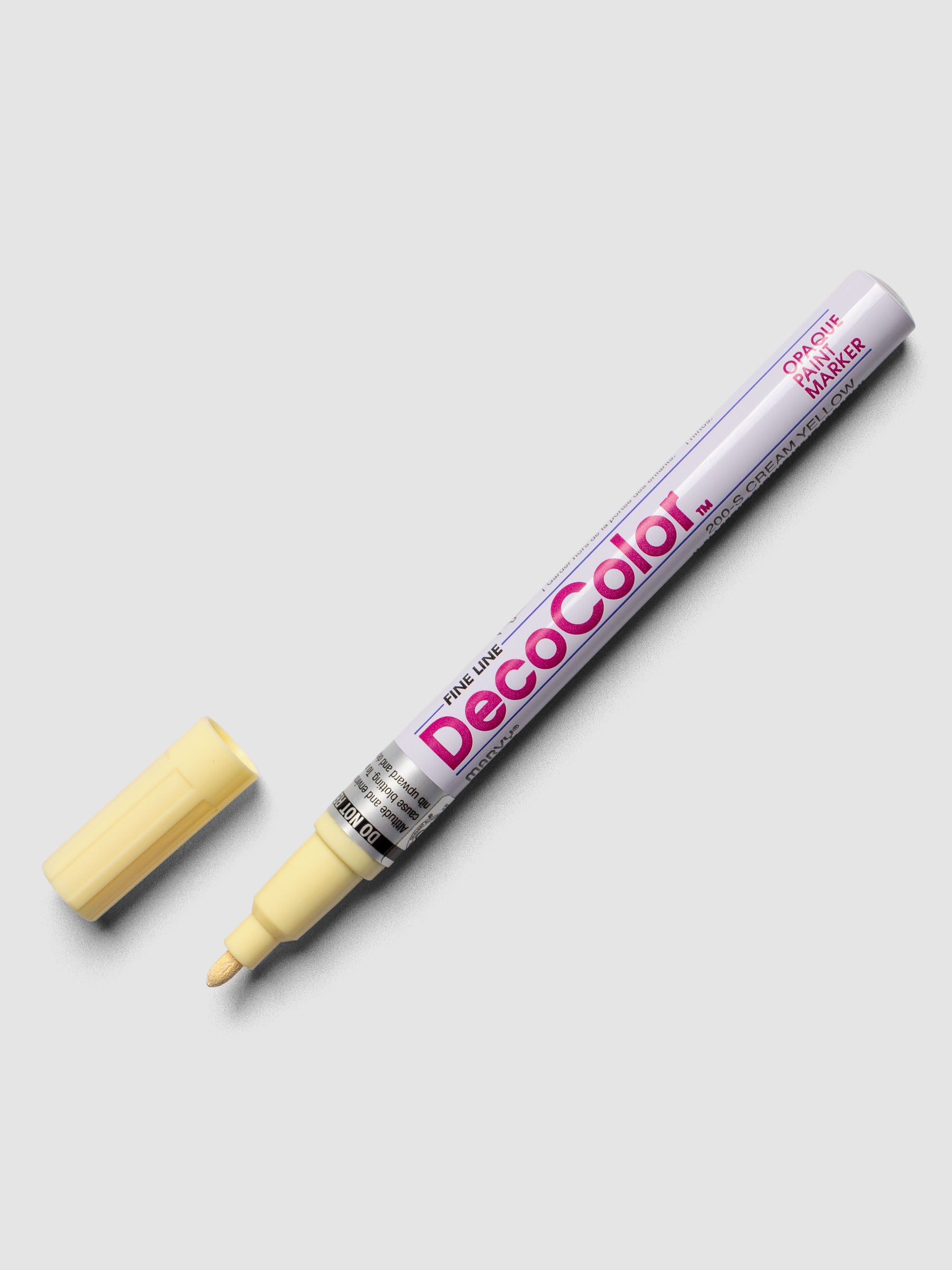 Cream Yellow DecoColor paint marker in fine shown with cap removed.