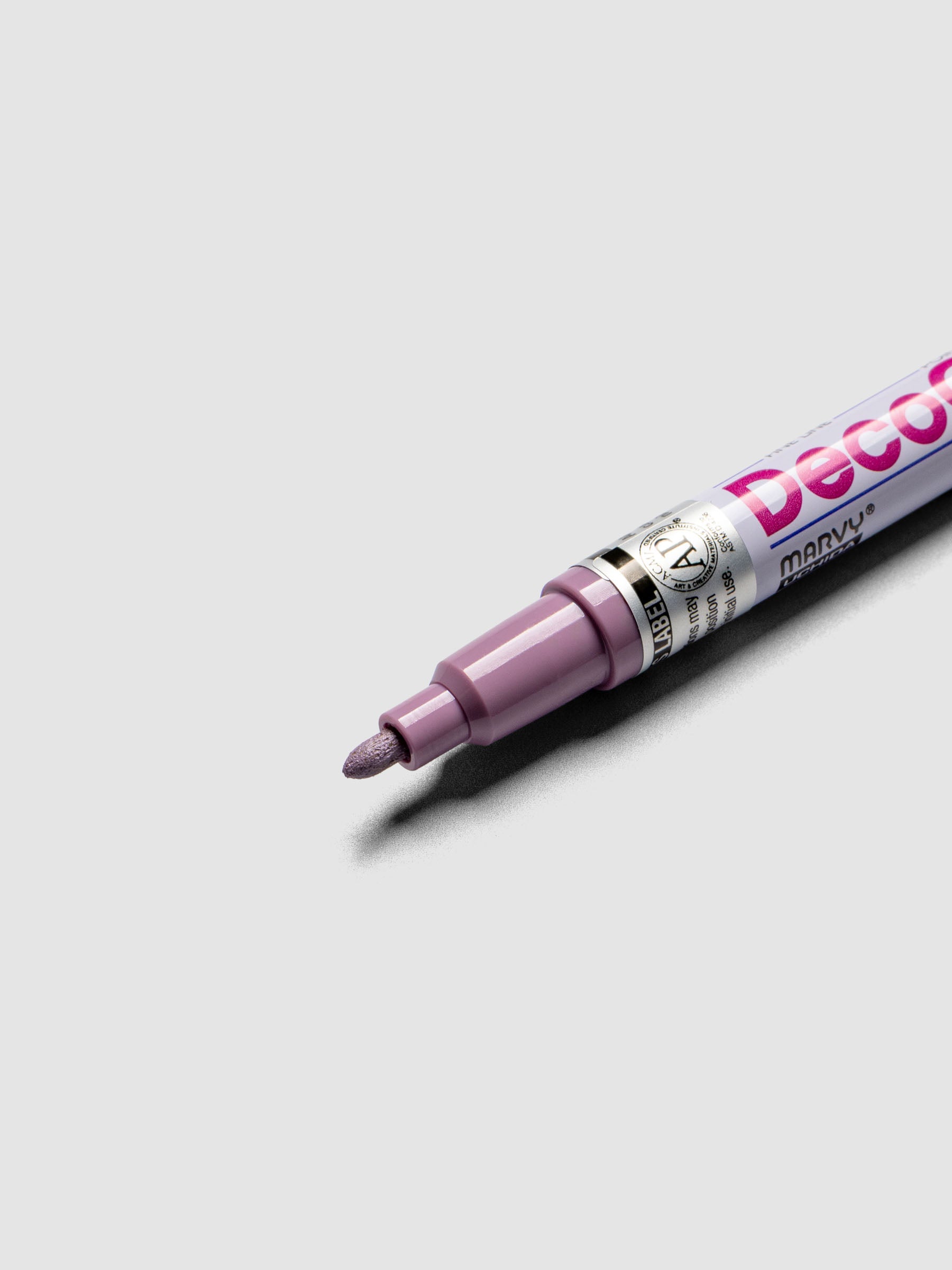 Close up of the Pale Mauve DecoColor paint marker in fine showing the nib