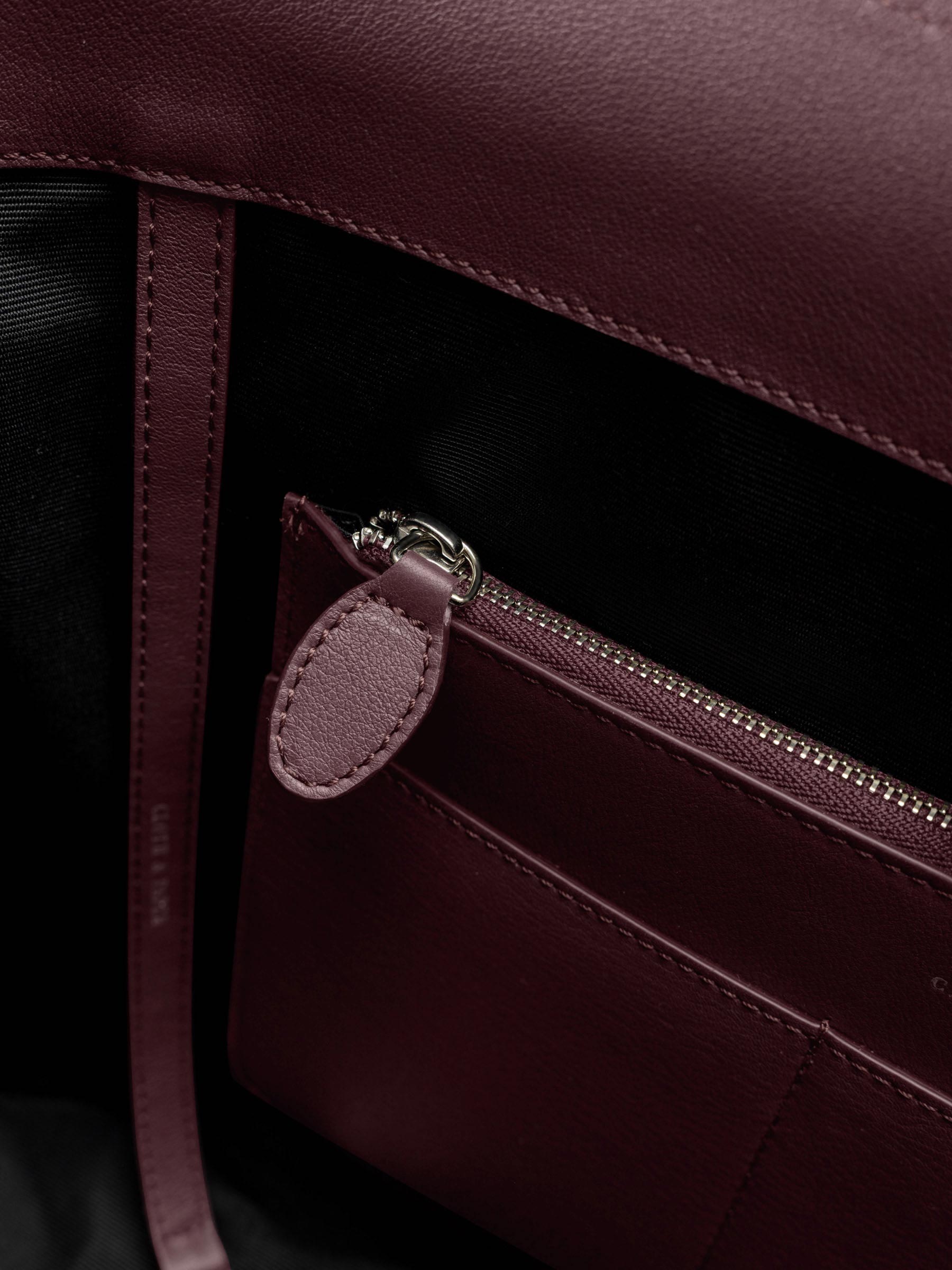 Detail view of the zip closure inner  pocket on The Metro Tote in the color Madrid.