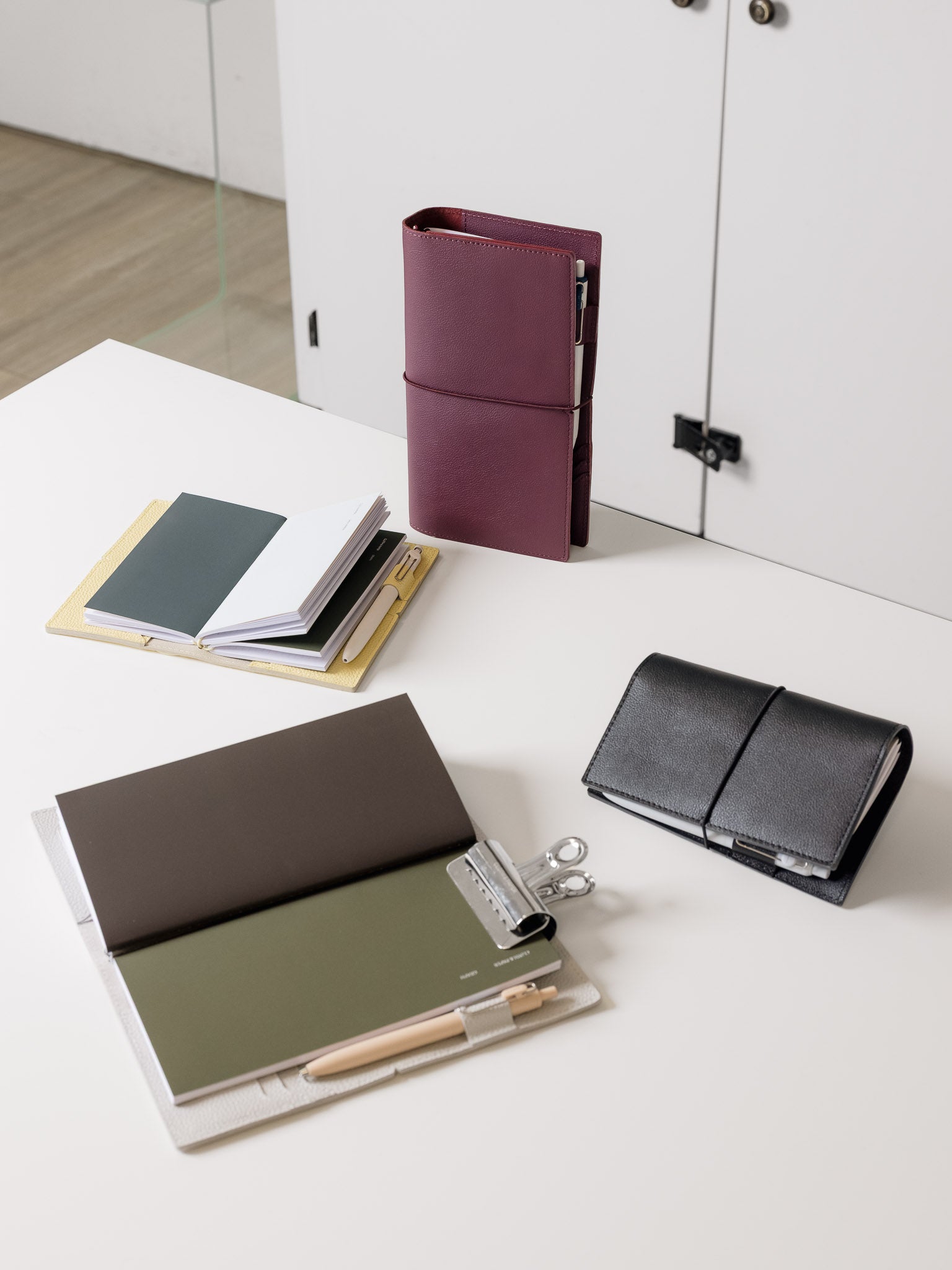 Leather travel notebook covers in a variety of colors with travel notetbooks inside.