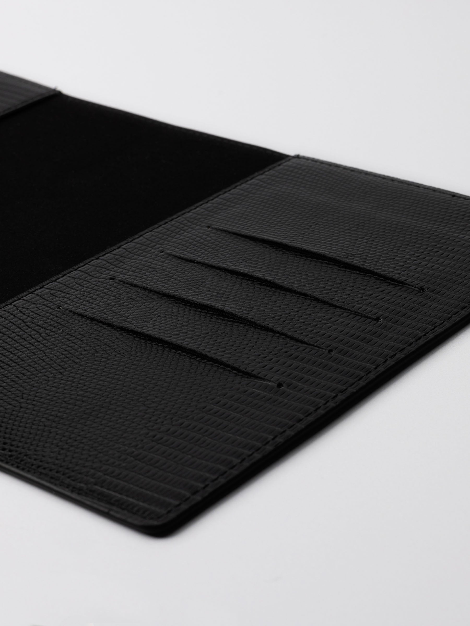 Closeup of folio. Four credit card slots are visible. Color shown is black.