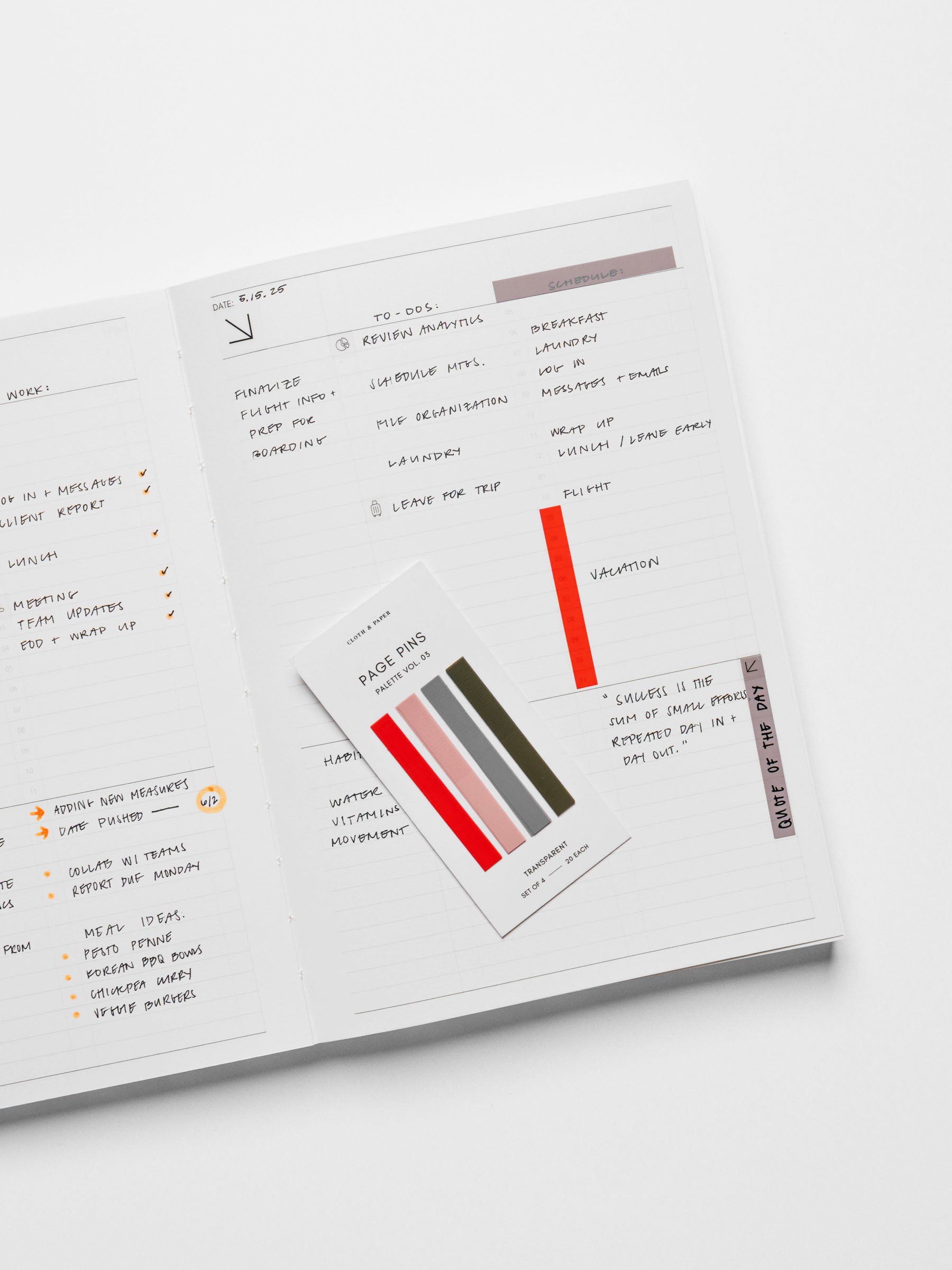 Page pins displayed on their backing, placed inside a notebook.