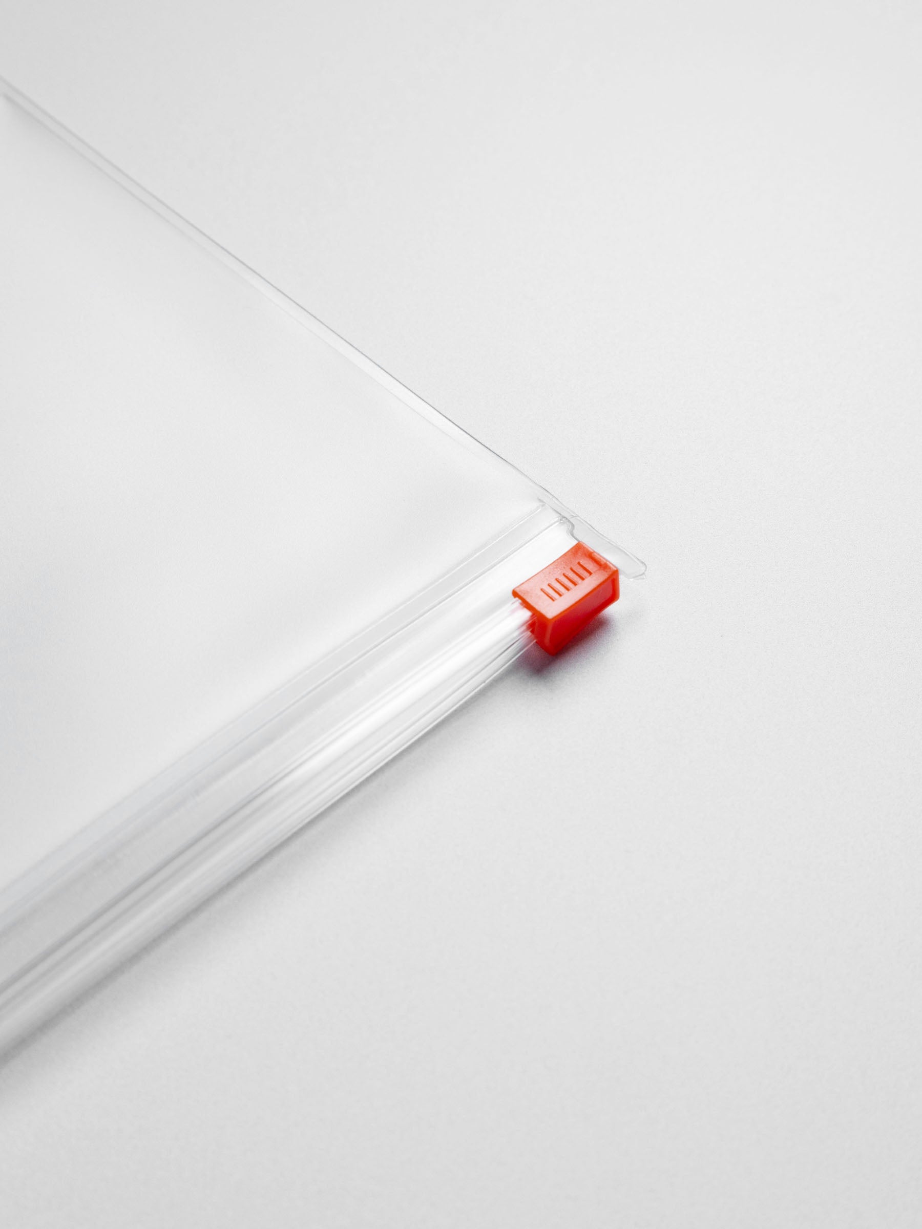 Closeup of orange zipper on dashboard.