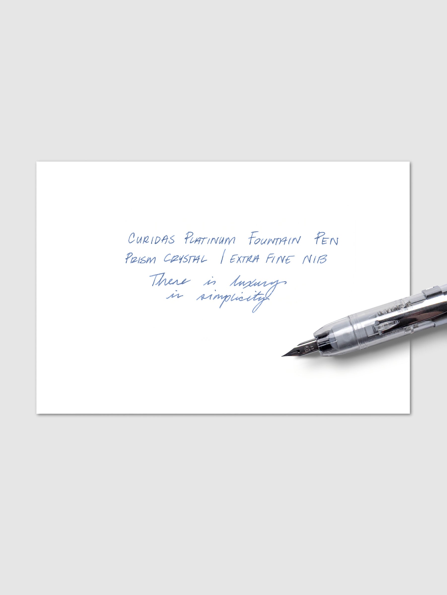 Writing sample with Platinum Curidas pen shown on a neutral background. Ink color is blue.