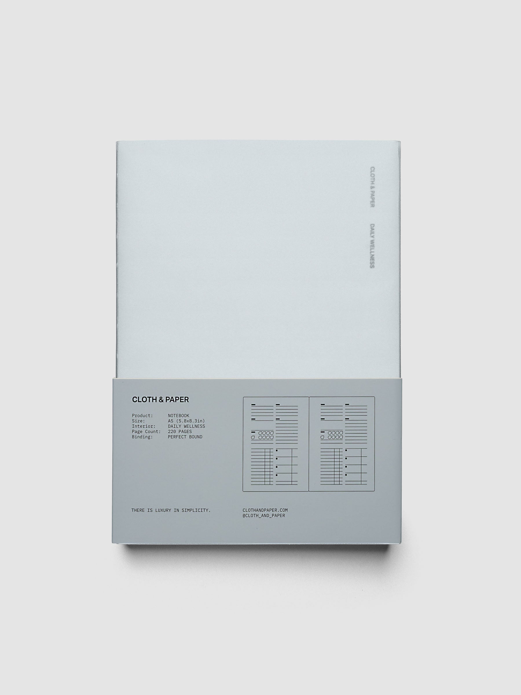 Perfect Bound Notebook | A5 | Daily Wellness shown closed on a neutral background, light blue cover with a printed layout key