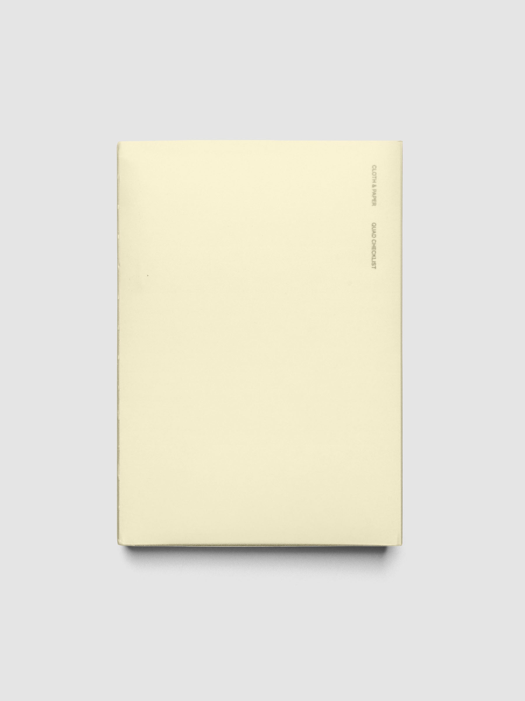 Perfect Bound Notebook | A5 | Quad Checklist shown closed on a neutral background, plain pale yellow cover