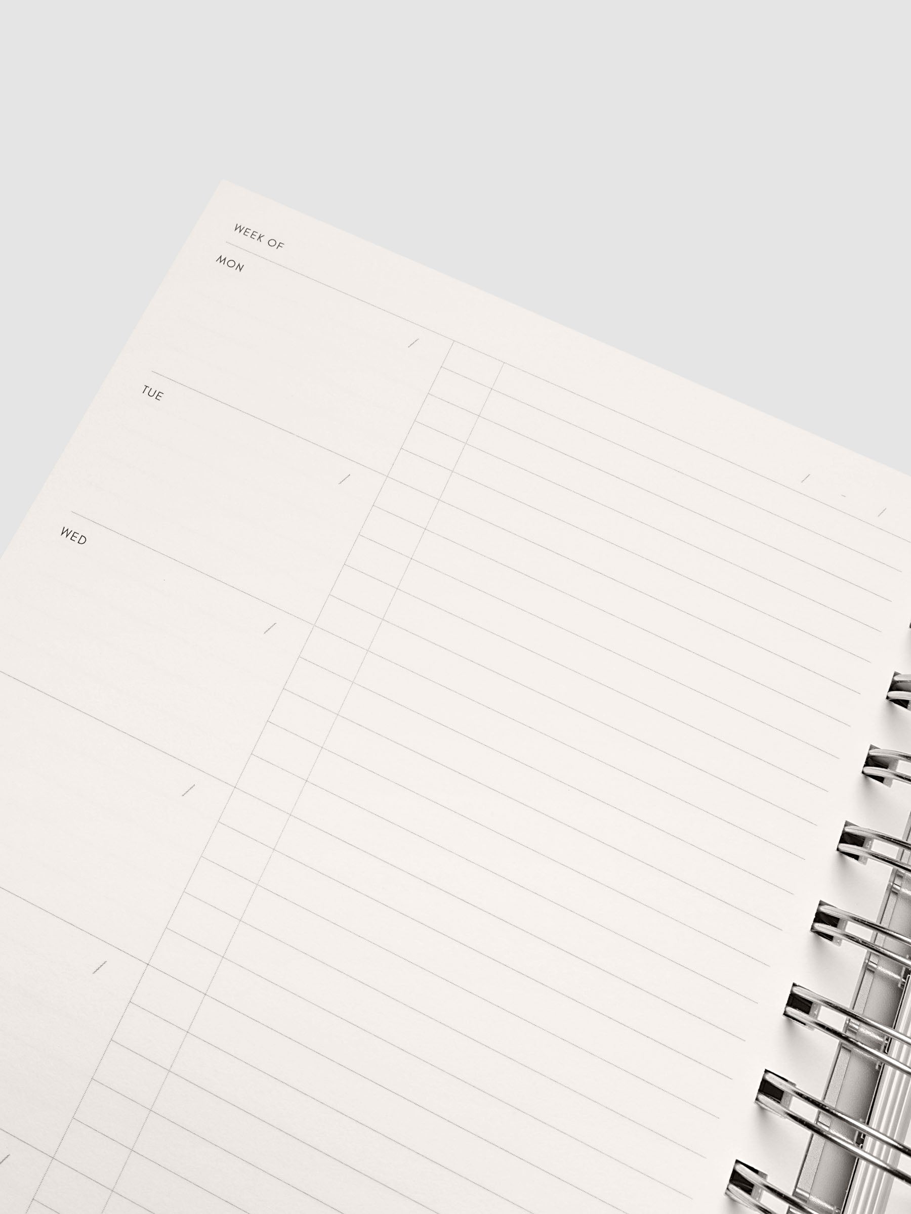 Close up of the Spiral Notebook | A5 | Weekly Checklist open at an angle, ruled pages with silver spiral binding along the edge