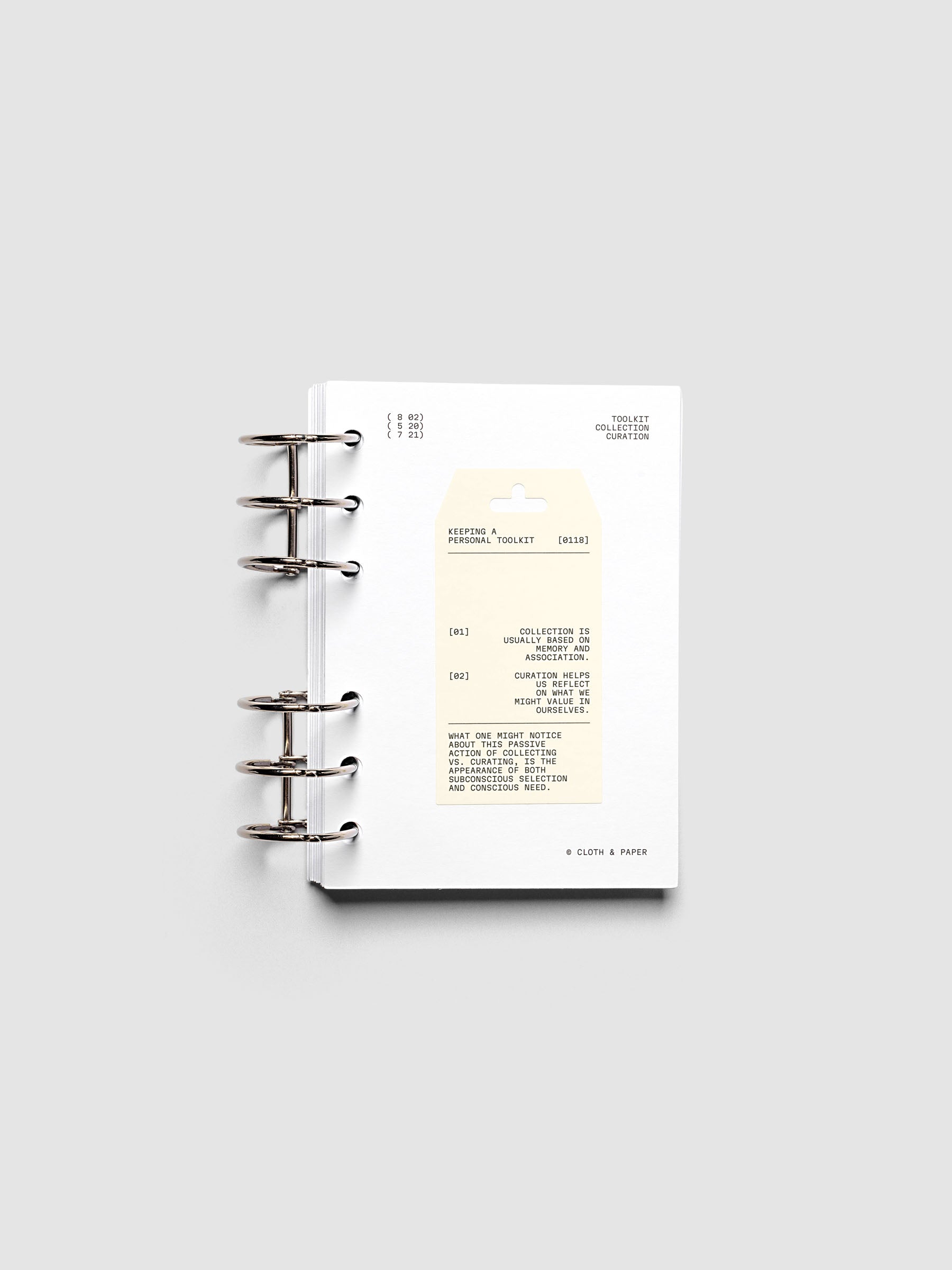 Personal Toolkit Planner Dashboard in A6 6-Ring Punch, a cardstock dashboard with an affixed warm gray printed tag in black type on a light gray background