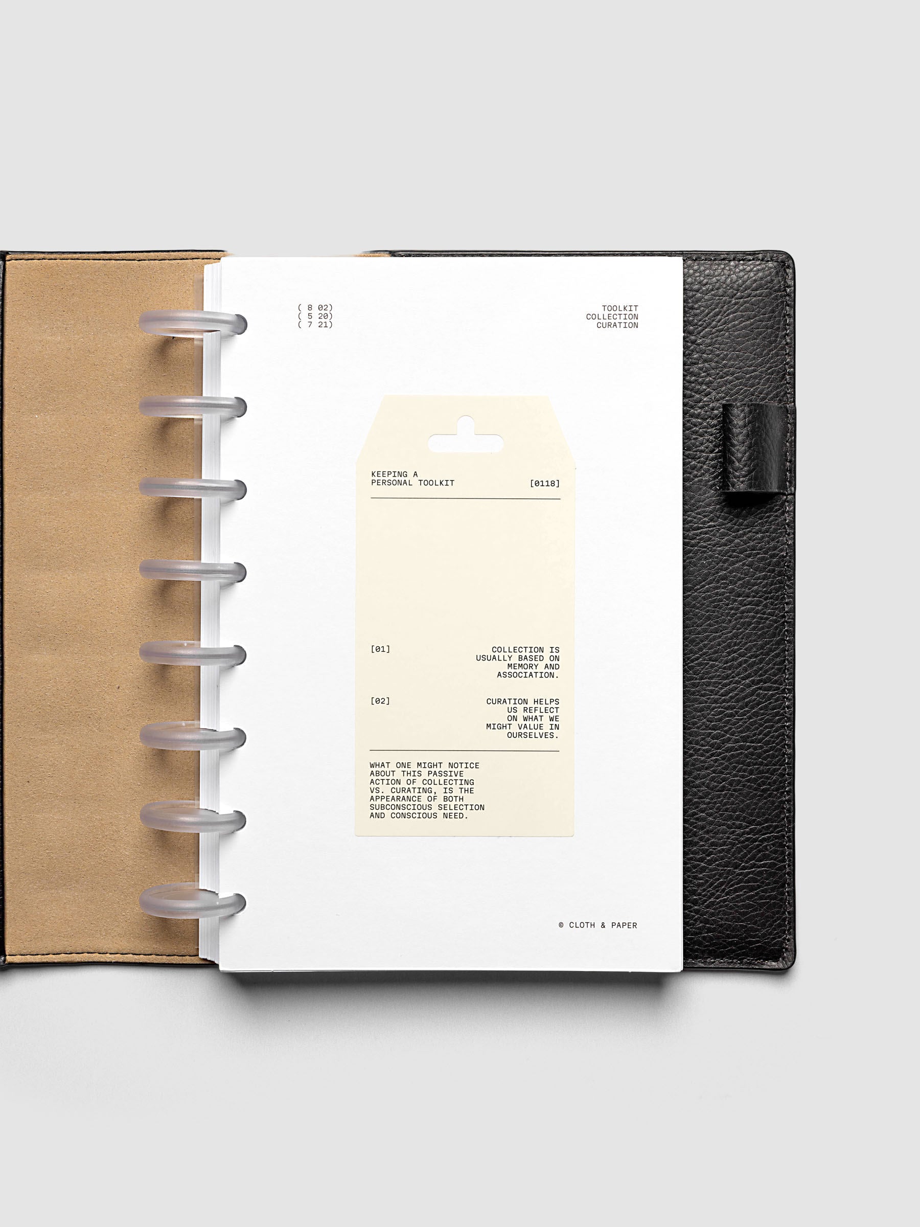 Personal Toolkit Planner Dashboard in Half Letter 8-Disc Punch, a cardstock dashboard with an affixed warm gray printed tag in black type on a light gray background