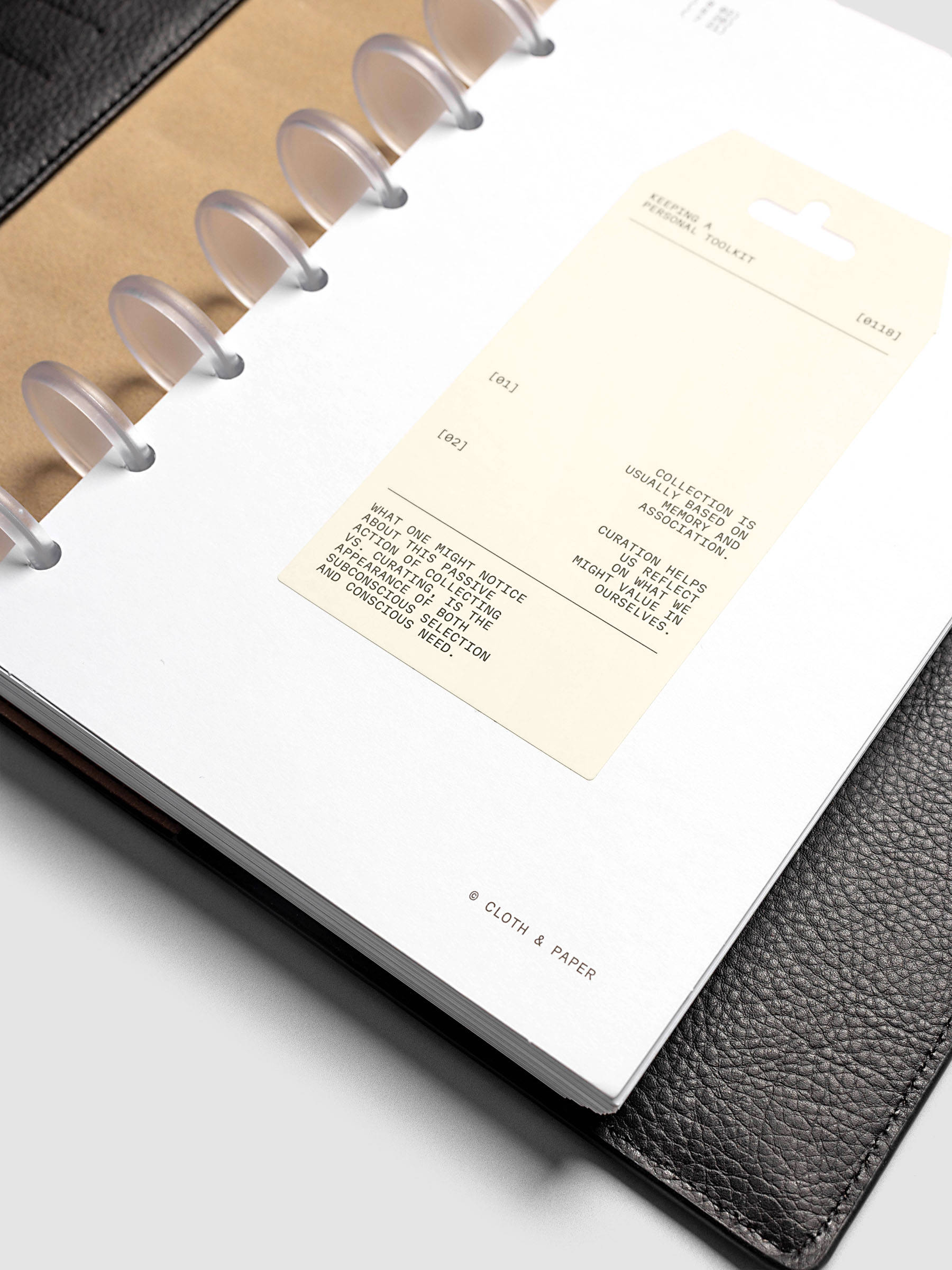 Personal Toolkit Planner Dashboard in Half Letter 8-Disc Punch, a cardstock dashboard with an affixed warm gray printed tag in black type on a light gray background