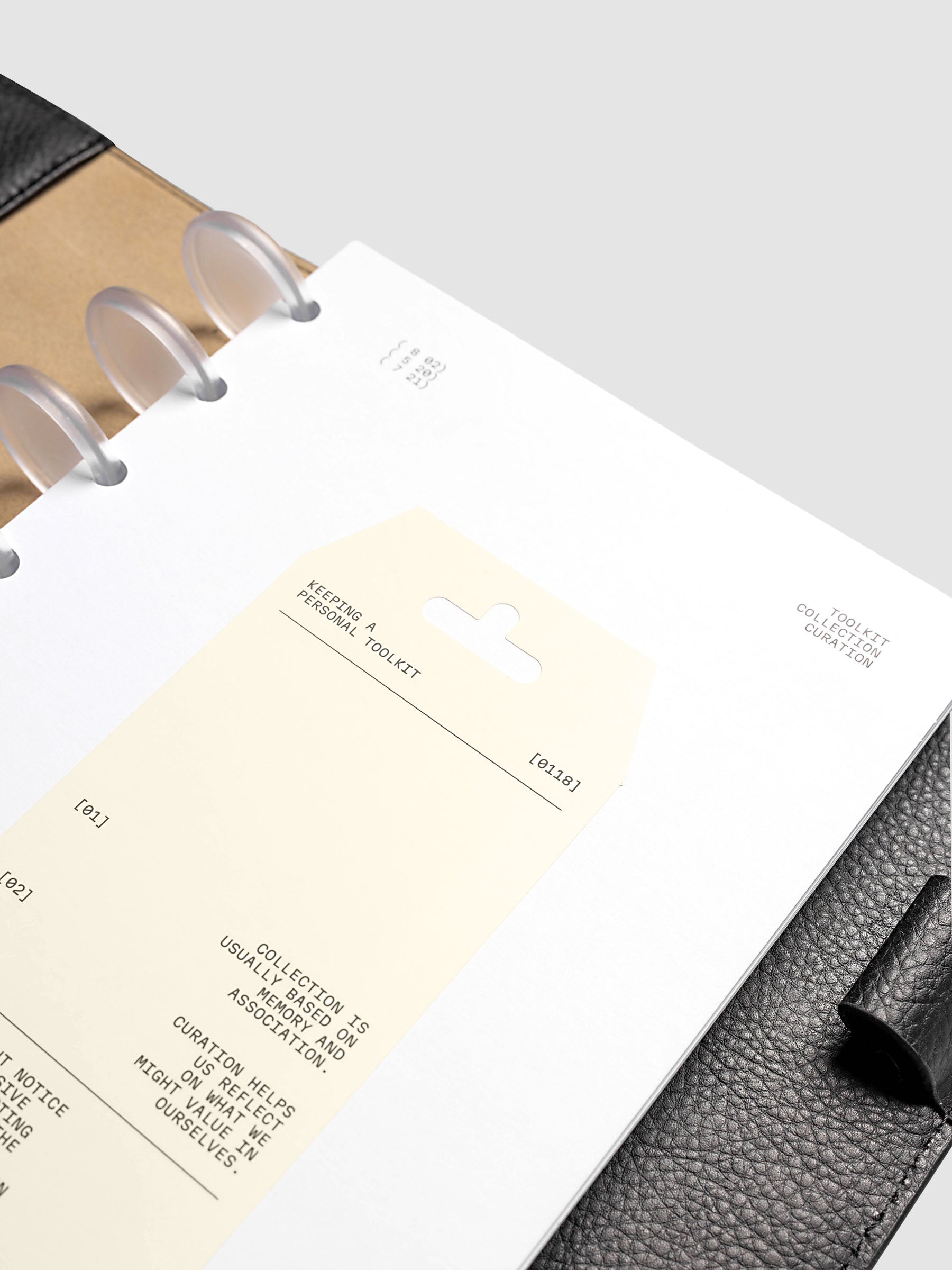 Personal Toolkit Planner Dashboard in Half Letter 8-Disc Punch, a cardstock dashboard with an affixed warm gray printed tag in black type on a light gray background