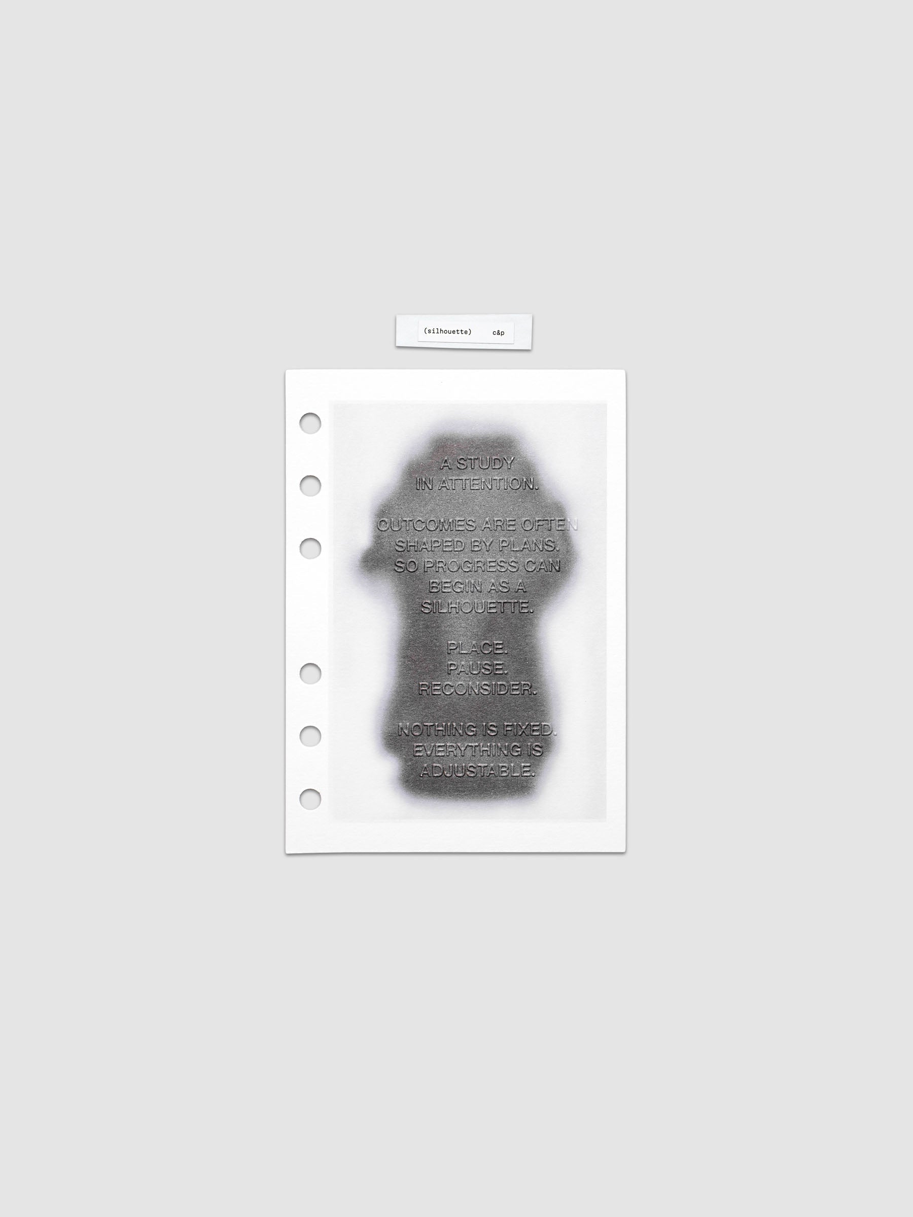 Silhouette Planner Dashboard in A6. Greyscale silhouette print with embossed text on paper. Image 1 of 2.