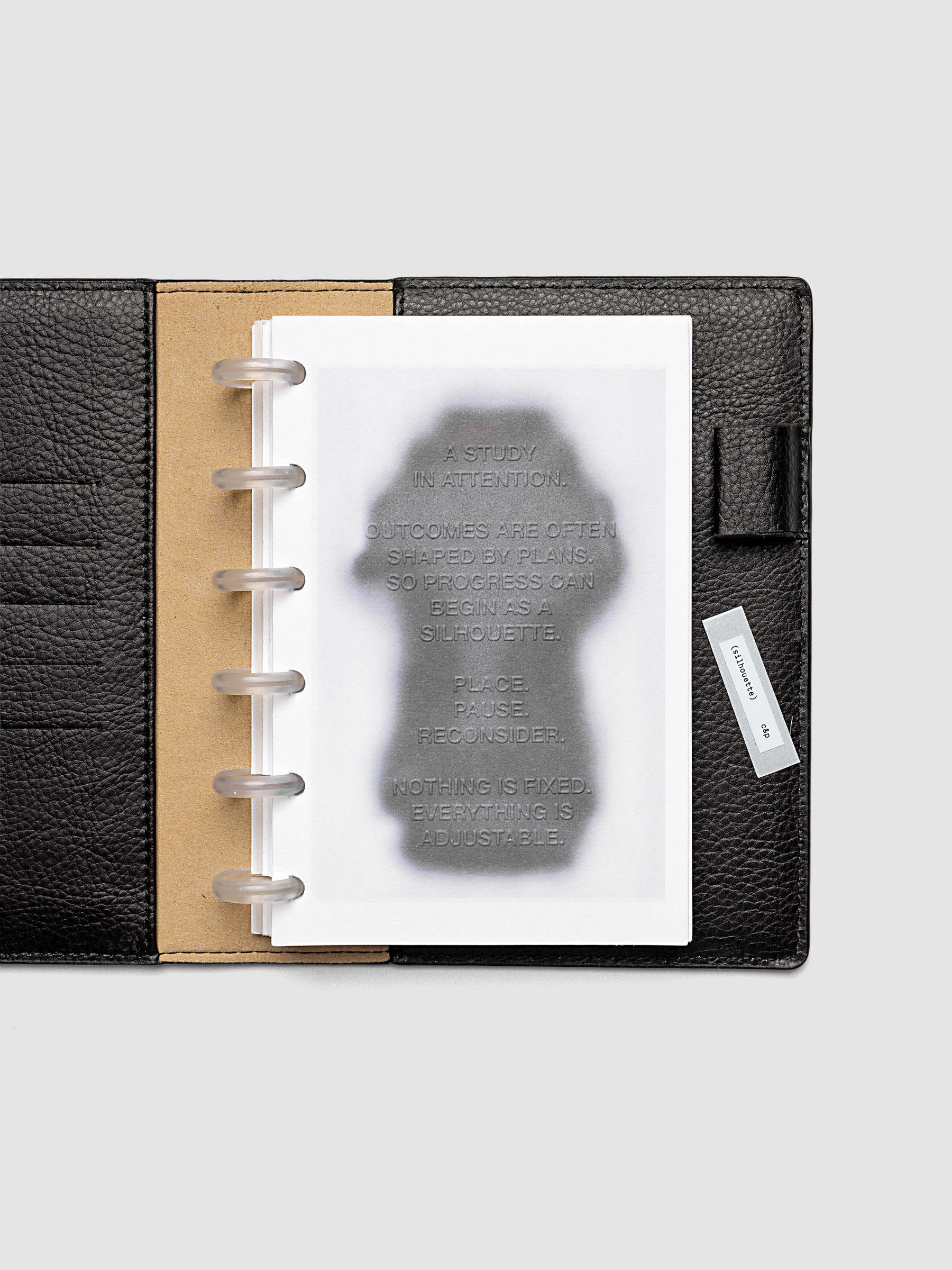 Silhouette Planner Dashboard in CP Petite. Greyscale silhouette print with embossed text on paper. Image 2 of 2.