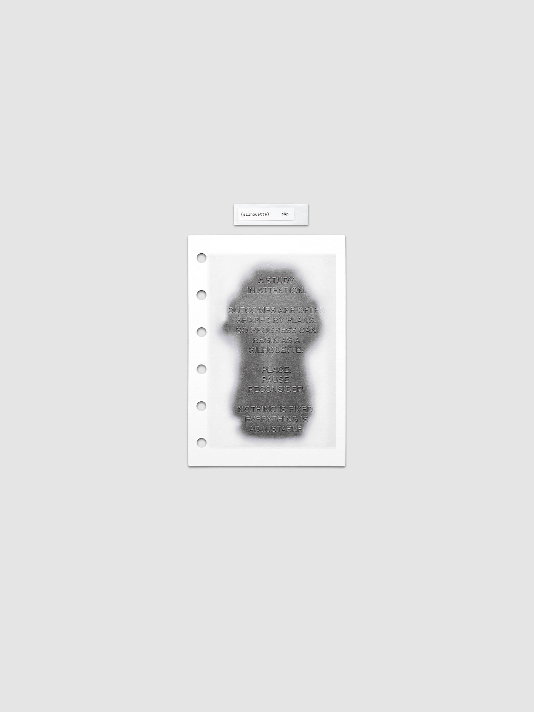 Silhouette Planner Dashboard in Pocket. Greyscale silhouette print with embossed text on paper. Image 1 of 2.