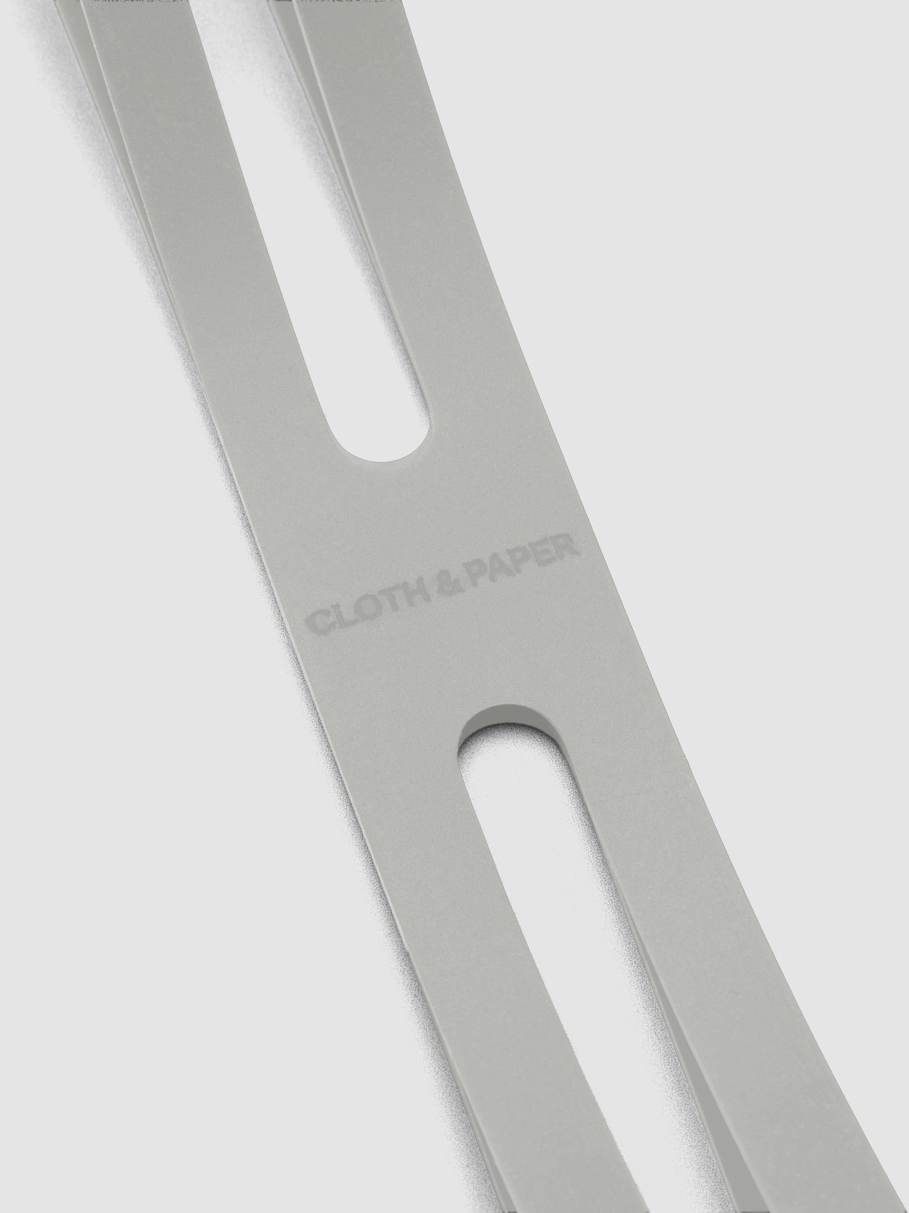 Close up of the debossed Cloth and Paper logo on the small ash planner closure band.