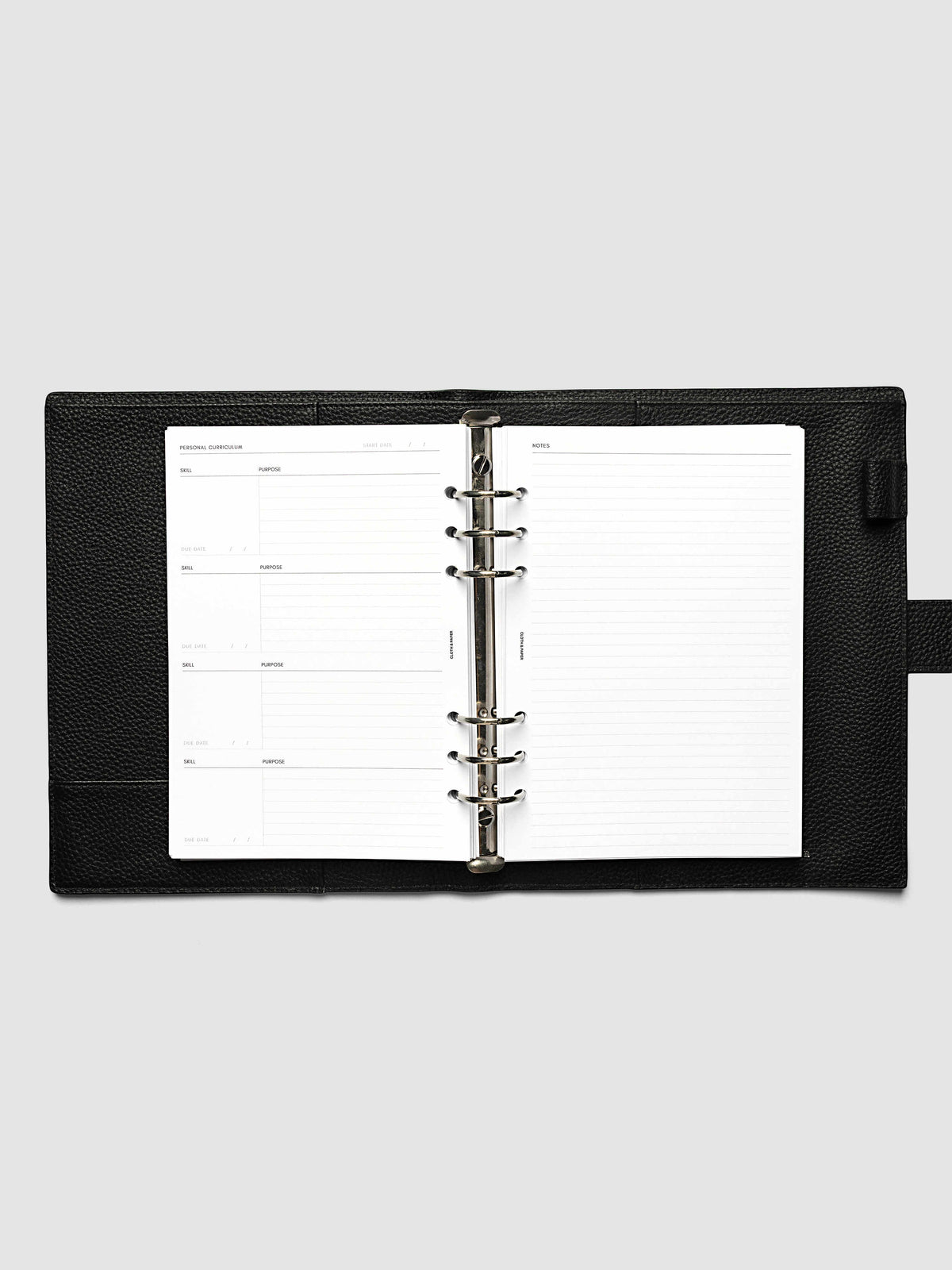 The A5 6-Ring Punch Personal Curriculum Planner Inserts open in a black leather ring bound planner to the index spread, four skill entries with purpose and due date on the left and a lined notes page on the right