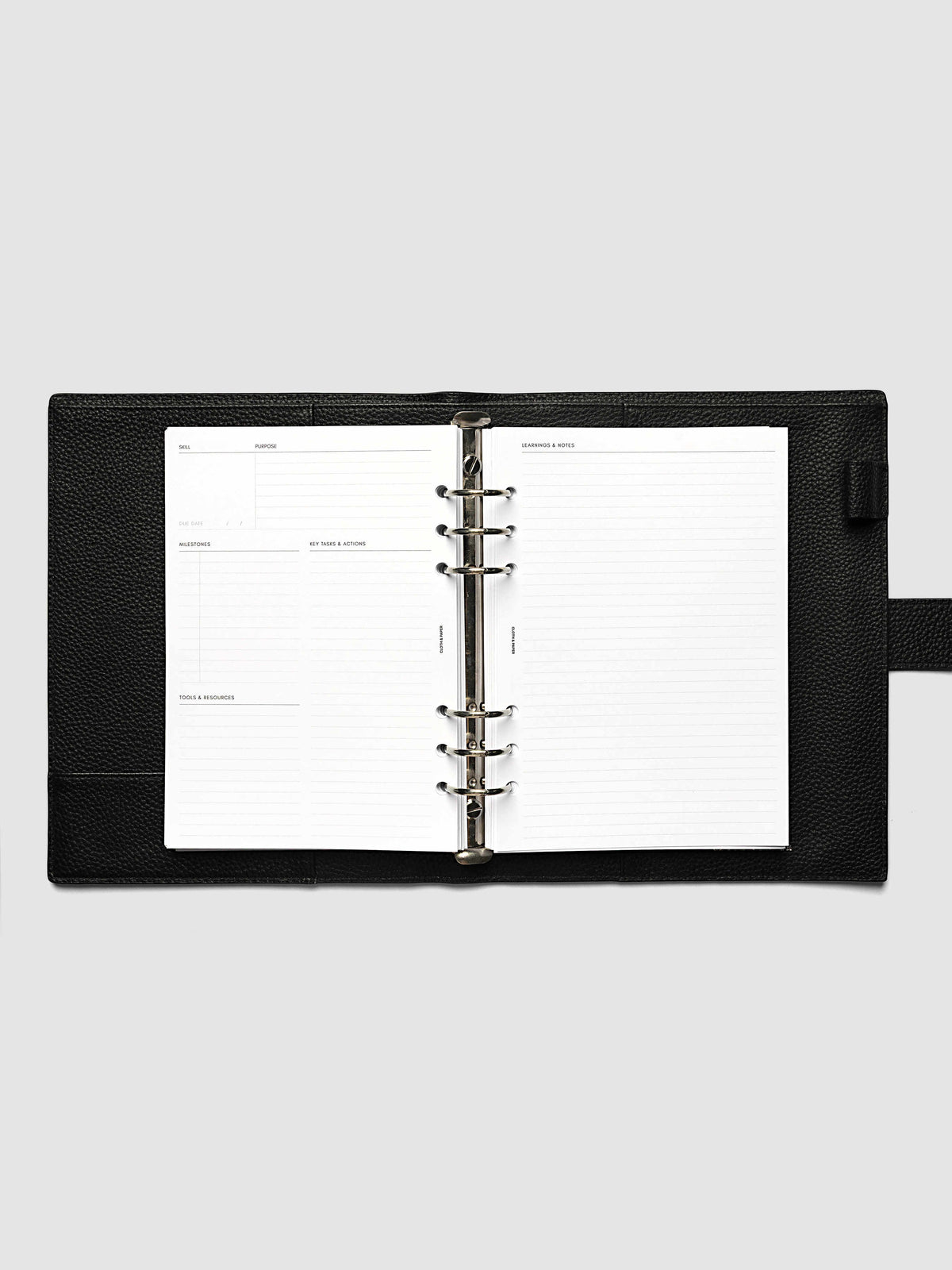 The A5 6-Ring Punch Personal Curriculum Planner Inserts open in a black leather ring bound planner to a skill spread, with skill, purpose, milestones, key tasks and resources on the left and lined learnings and notes on the right