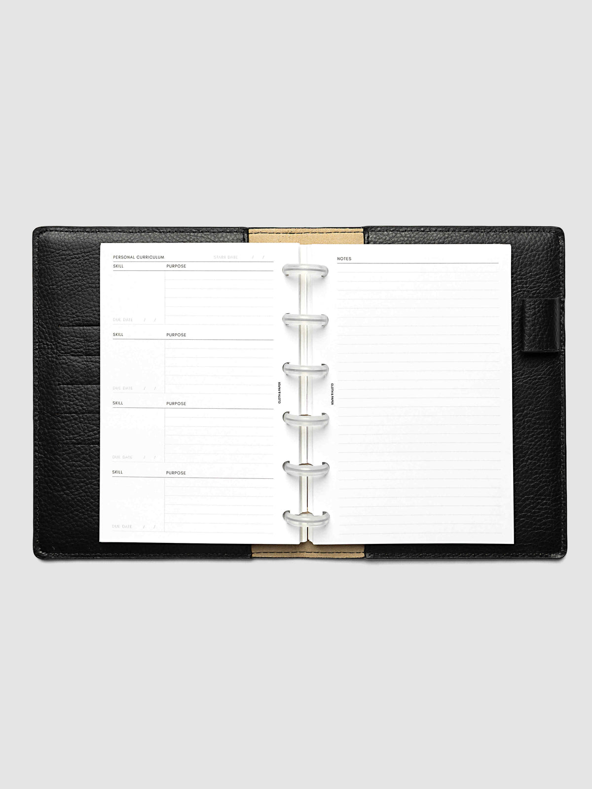 The CP Petite 6-Disc Punch Personal Curriculum Planner Inserts open in a black leather ring bound planner to the index spread, four skill entries with purpose and due date on the left and a lined notes page on the right