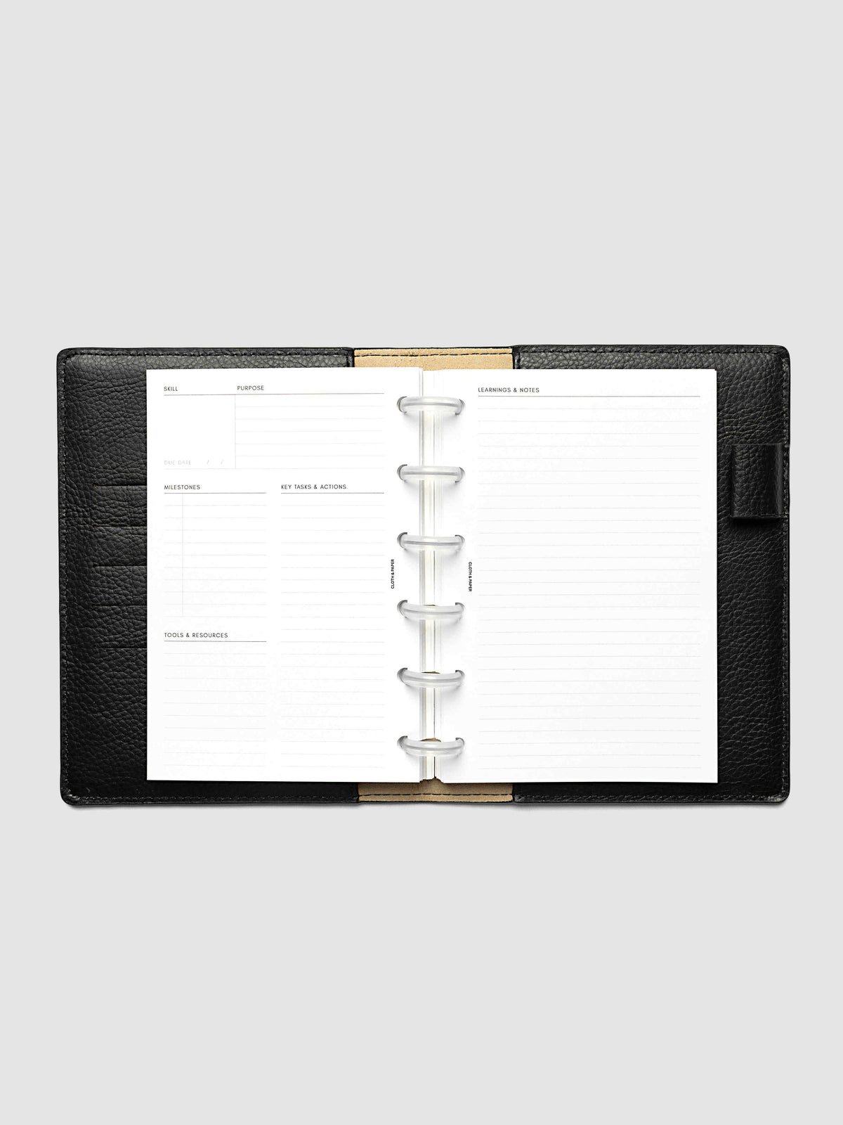 The CP Petite 6-Disc Punch Personal Curriculum Planner Inserts open in a black leather ring bound planner to a skill spread, with skill, purpose, milestones, key tasks and resources on the left and lined learnings and notes on the right