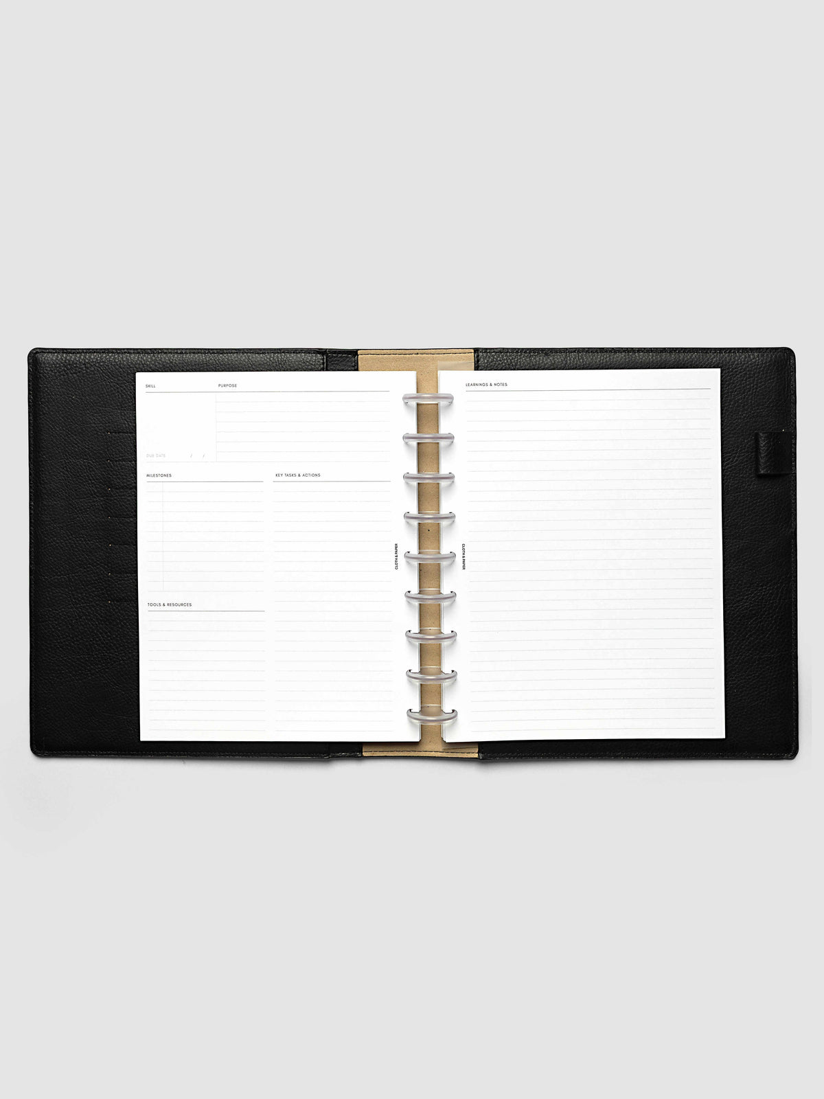 The HP Classic 9-Disc Punch Personal Curriculum Planner Inserts open in a black leather ring bound planner to a skill spread, with skill, purpose, milestones, key tasks and resources on the left and lined learnings and notes on the right