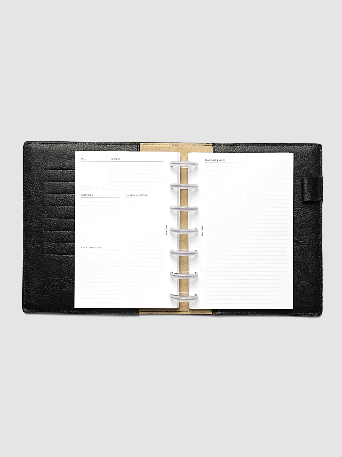 The HP Mini Personal Curriculum Planner Inserts open in a black leather ring bound planner to a skill spread, with skill, purpose, milestones, key tasks and resources on the left and lined learnings and notes on the right