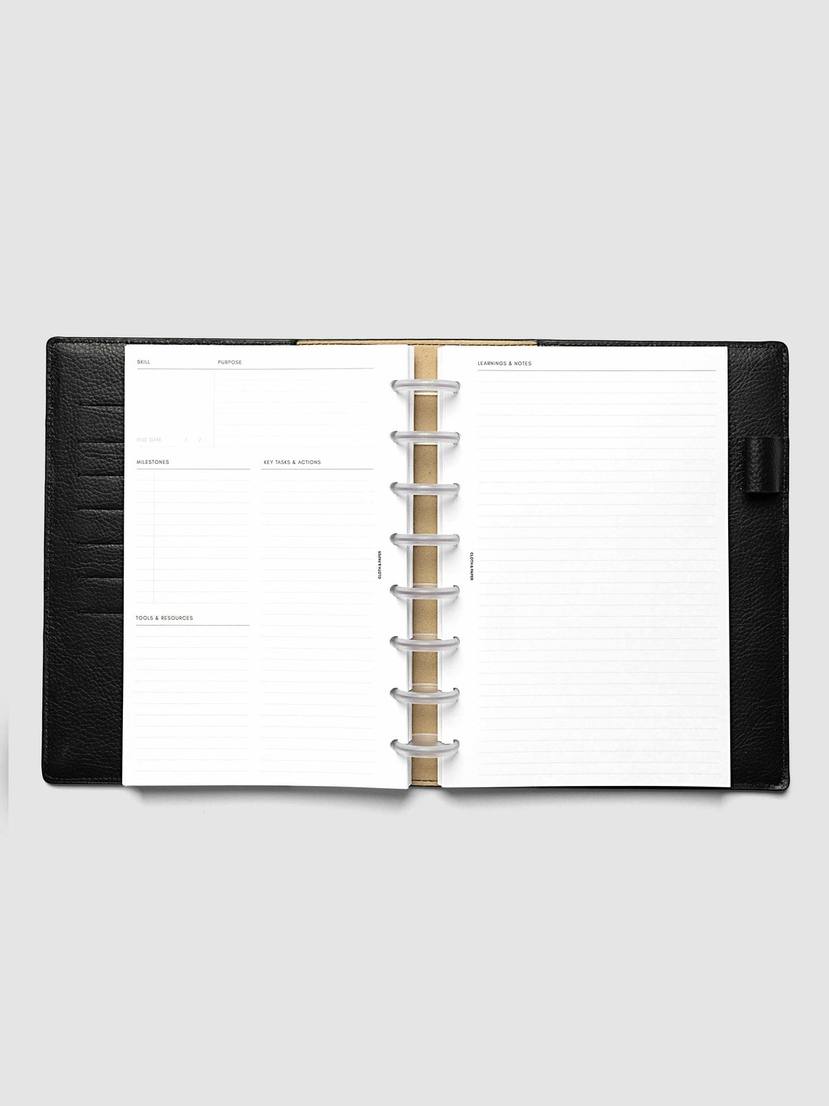 The Half Letter 8-Disc Punch Personal Curriculum Planner Inserts open in a black leather ring bound planner to a skill spread, with skill, purpose, milestones, key tasks and resources on the left and lined learnings and notes on the right