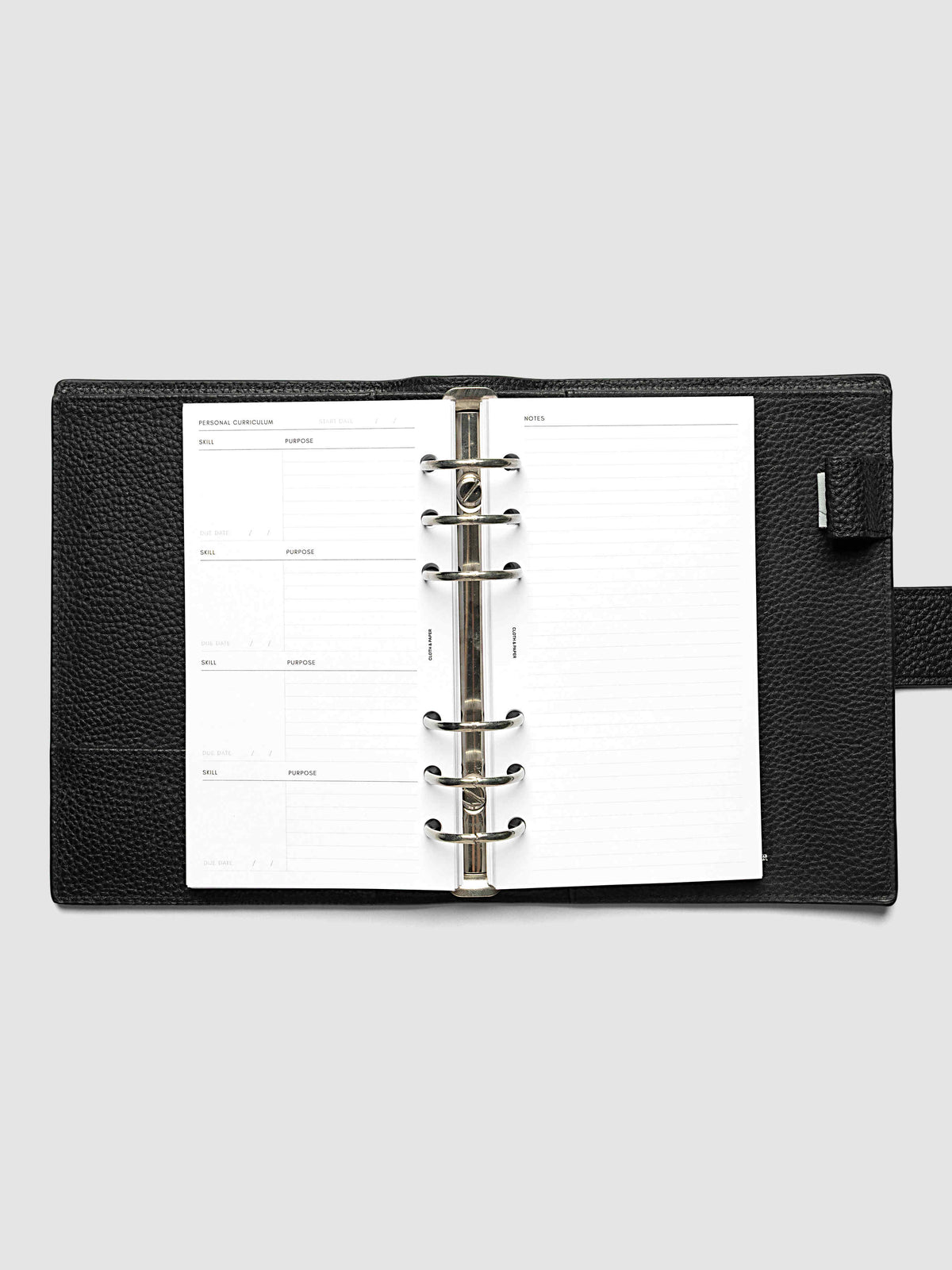 The Personal Personal Curriculum Planner Inserts open in a black leather ring bound planner to a skill spread, with skill, purpose, milestones, key tasks and resources on the left and lined learnings and notes on the right