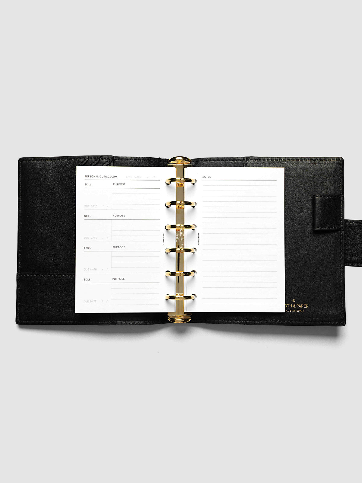 The Pocket Personal Curriculum Planner Inserts open in a black leather ring bound planner to the index spread, four skill entries with purpose and due date on the left and a lined notes page on the right