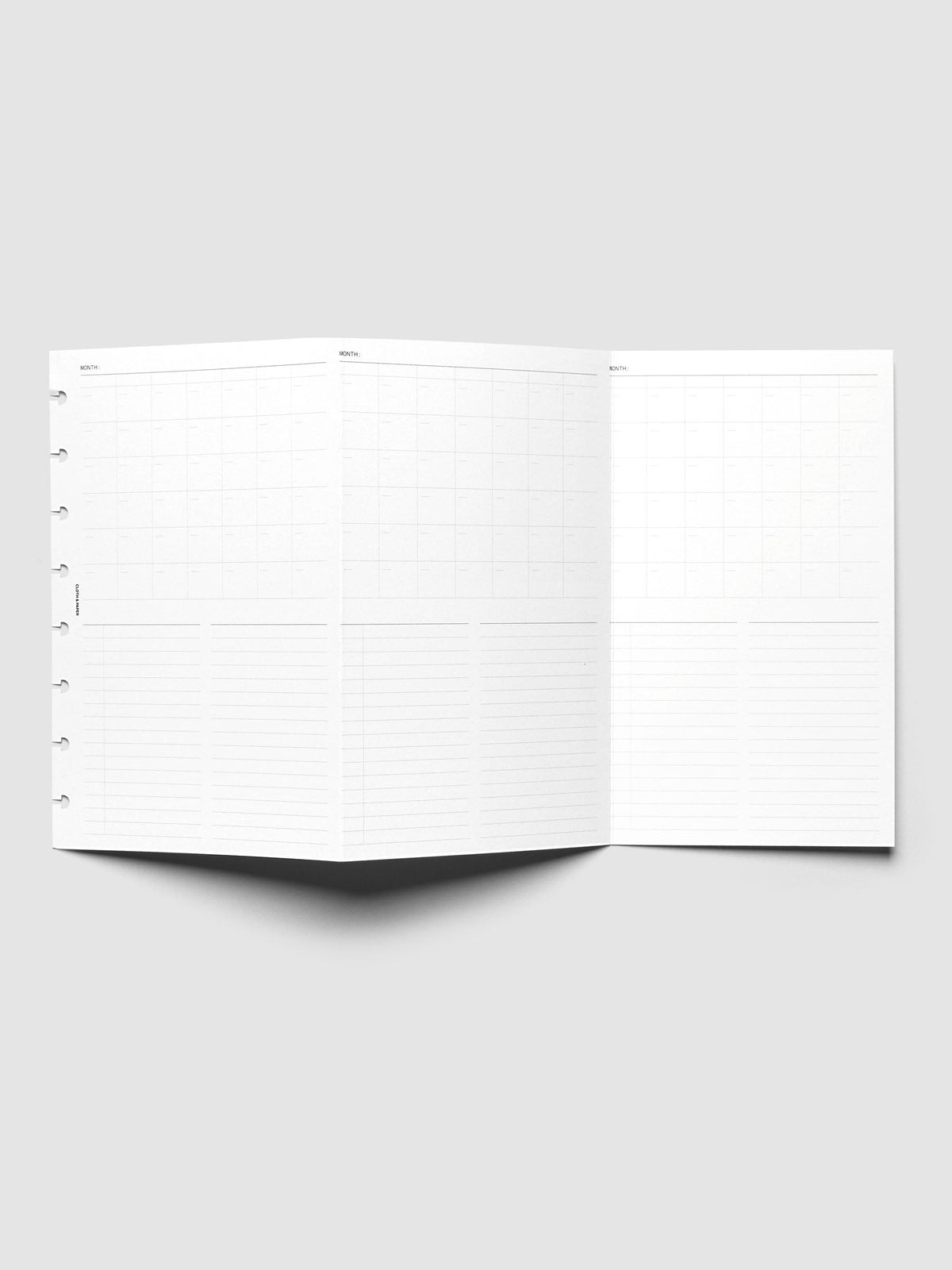 Monthly Fold Out Planner Insert Set of 2, Half Letter 8-Disc Punch, the insert unfolded and standing open on a pale gray surface, three monthly panels visible across the fold