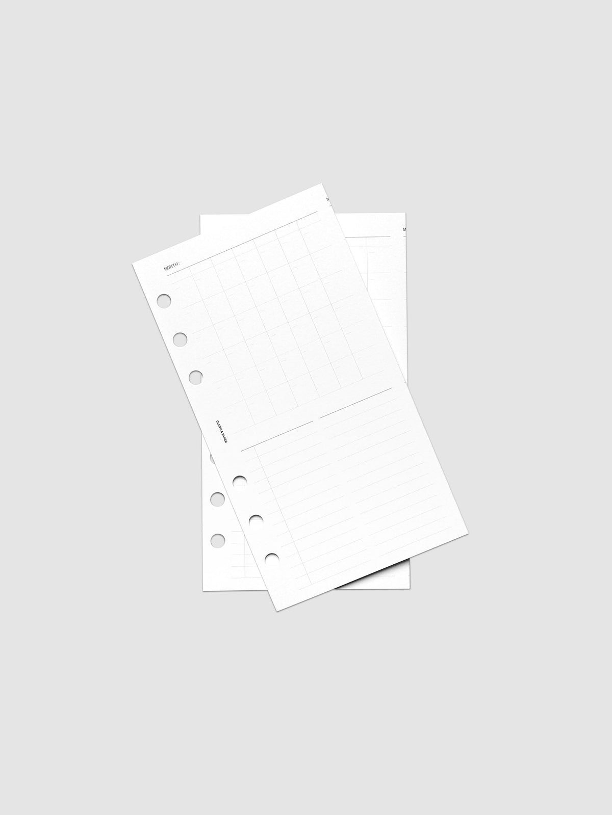 Monthly Fold Out Planner Insert Set of 2, Personal 6-Ring Punch, both inserts of the set layered at an angle on a pale gray surface