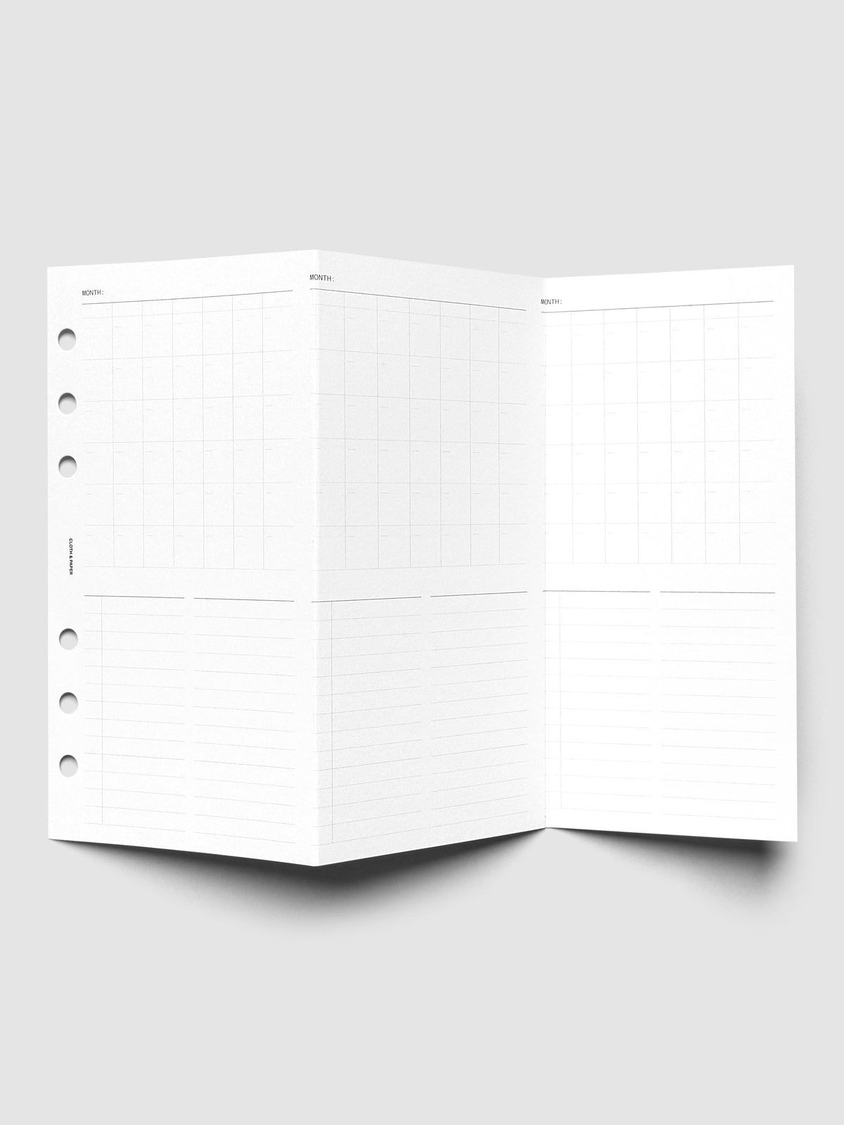 Monthly Fold Out Planner Insert Set of 2, Personal 6-Ring Punch, the insert unfolded and standing open, three tall monthly grid panels running across the folds