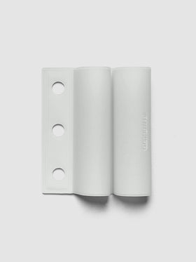 System Punch Pen Holder | Aspen, ring punch, pale gray holder shown flat with three round holes punched along the left edge on a light gray background
