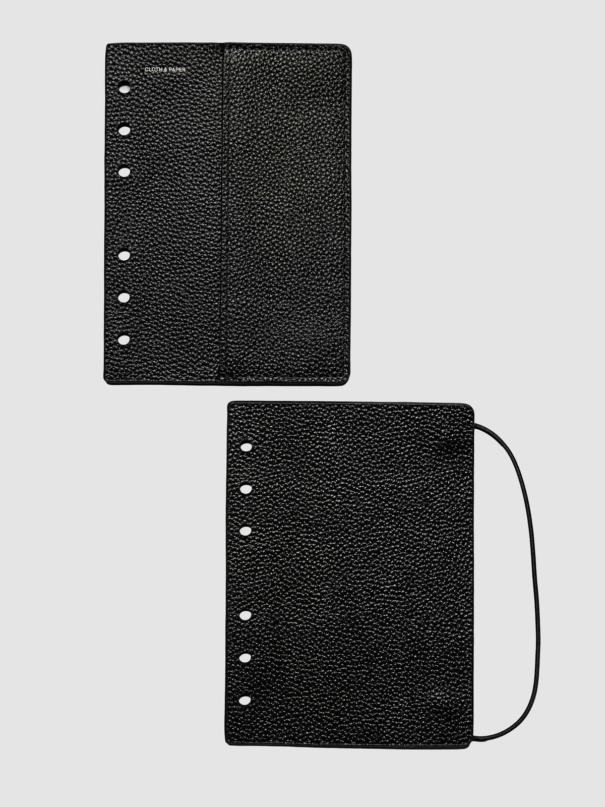 Both covers of the A6 Genuine Leather Planner Cover Set laid flat side by side, the front cover with its sewn pocket seam and the back cover with the bungee cord looping out from the edge