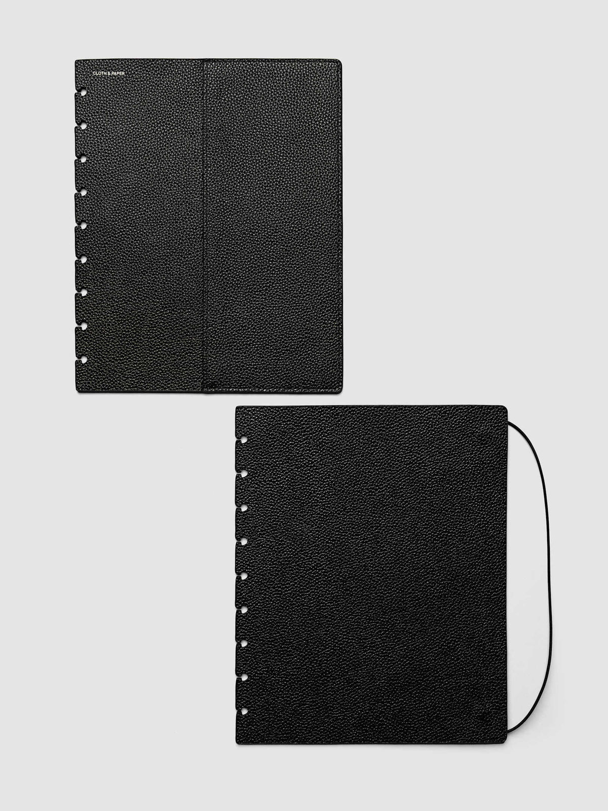 Both covers of the HP Classic 9-Disc Punch Genuine Leather Planner Cover Set laid flat side by side, the front cover with its sewn pocket seam and the back cover with the bungee cord looping out from the edge