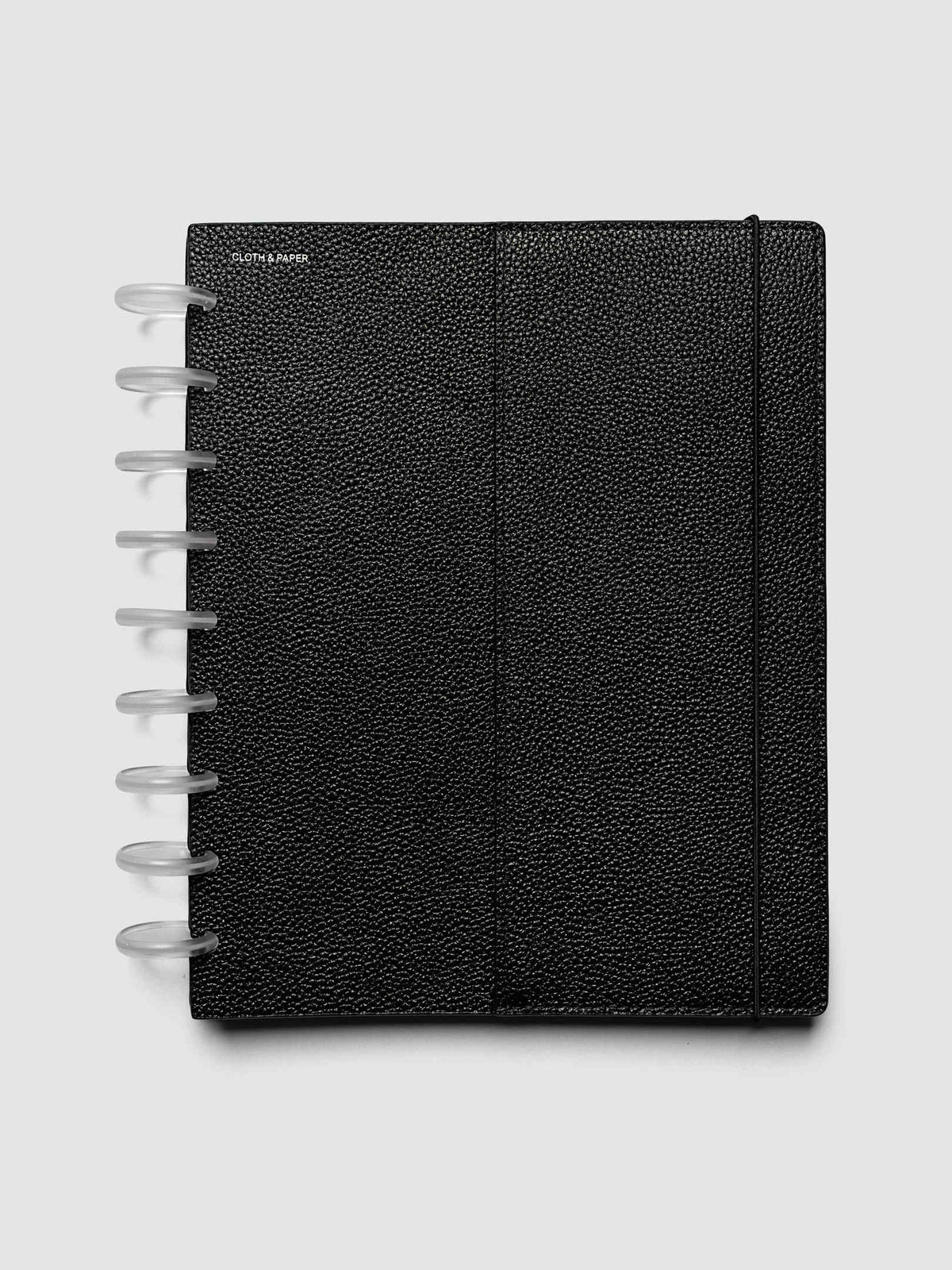 The HP Classic 9-Disc Punch Genuine Leather Planner Cover Set closed on a ring bound planner, showing the silver rings, the silver foiled logo, and the bungee cord holding the stack shut