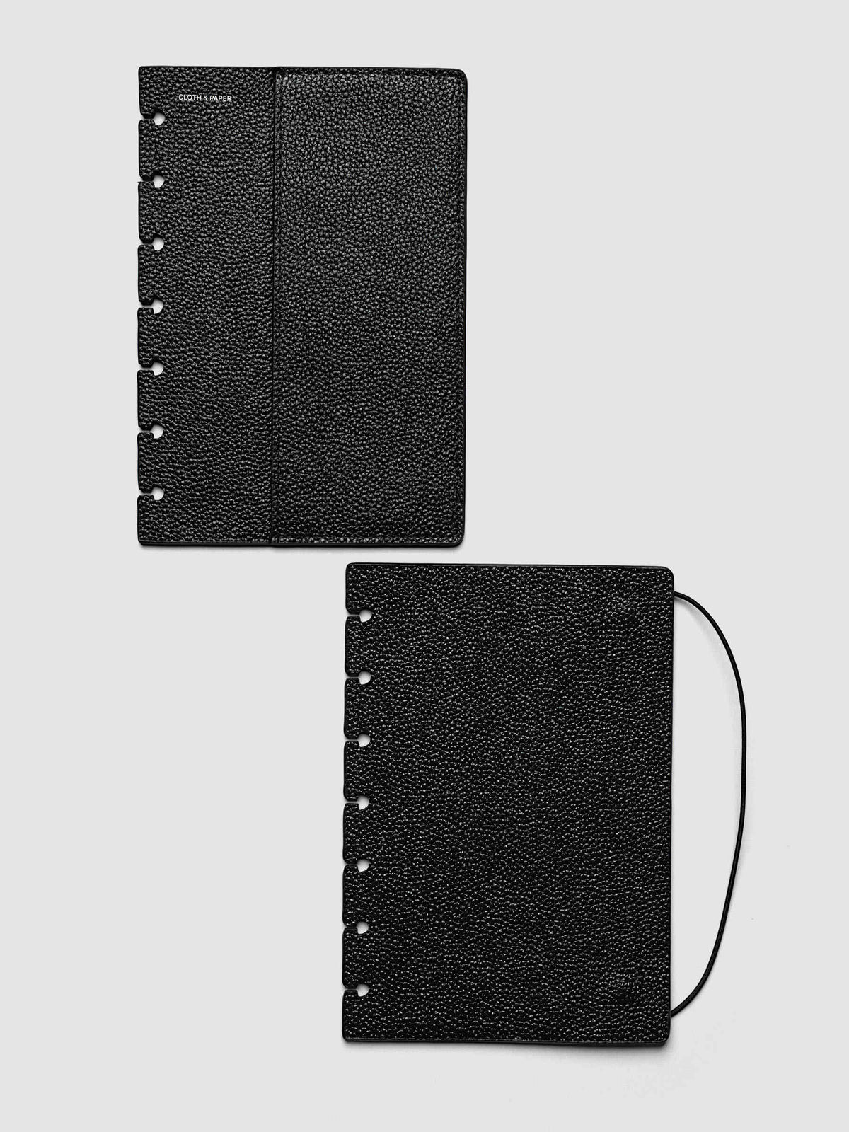 Both covers of the HP Mini Genuine Leather Planner Cover Set laid flat side by side, the front cover with its sewn pocket seam and the back cover with the bungee cord looping out from the edge