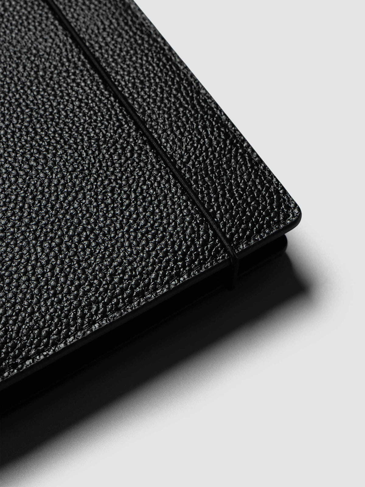 A red dot sticker sheet slipped into the vertical sewn pocket on the face of the front cover of the Half Letter 8-Disc Punch Genuine Leather Planner Cover Set