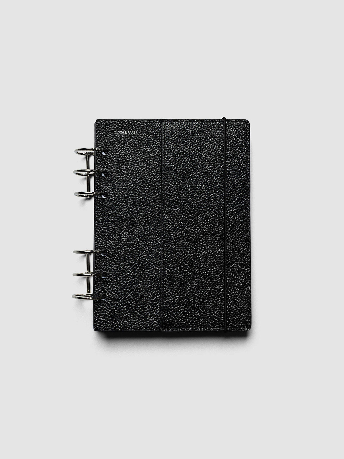 Both covers of the Personal Wide Genuine Leather Planner Cover Set laid flat side by side, the front cover with its sewn pocket seam and the back cover with the bungee cord looping out from the edge