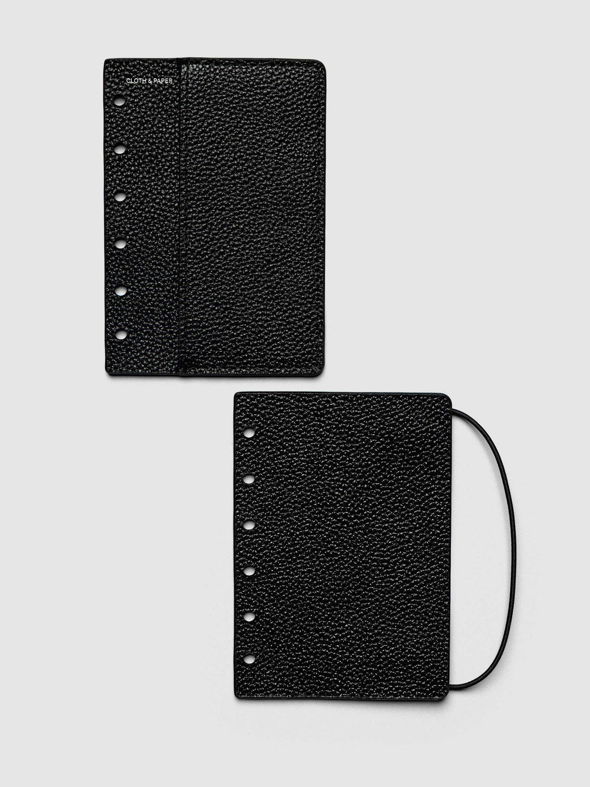 Both covers of the Pocket Genuine Leather Planner Cover Set laid flat side by side, the front cover with its sewn pocket seam and the back cover with the bungee cord looping out from the edge