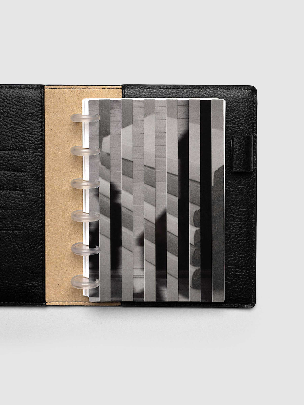 Both layers of the CP Petite 6-Disc Punch Strips Planner Dashboard Duo overlapping, the clear plastic top layer of silhouettes in motion set across the vellum base layer of stacked books