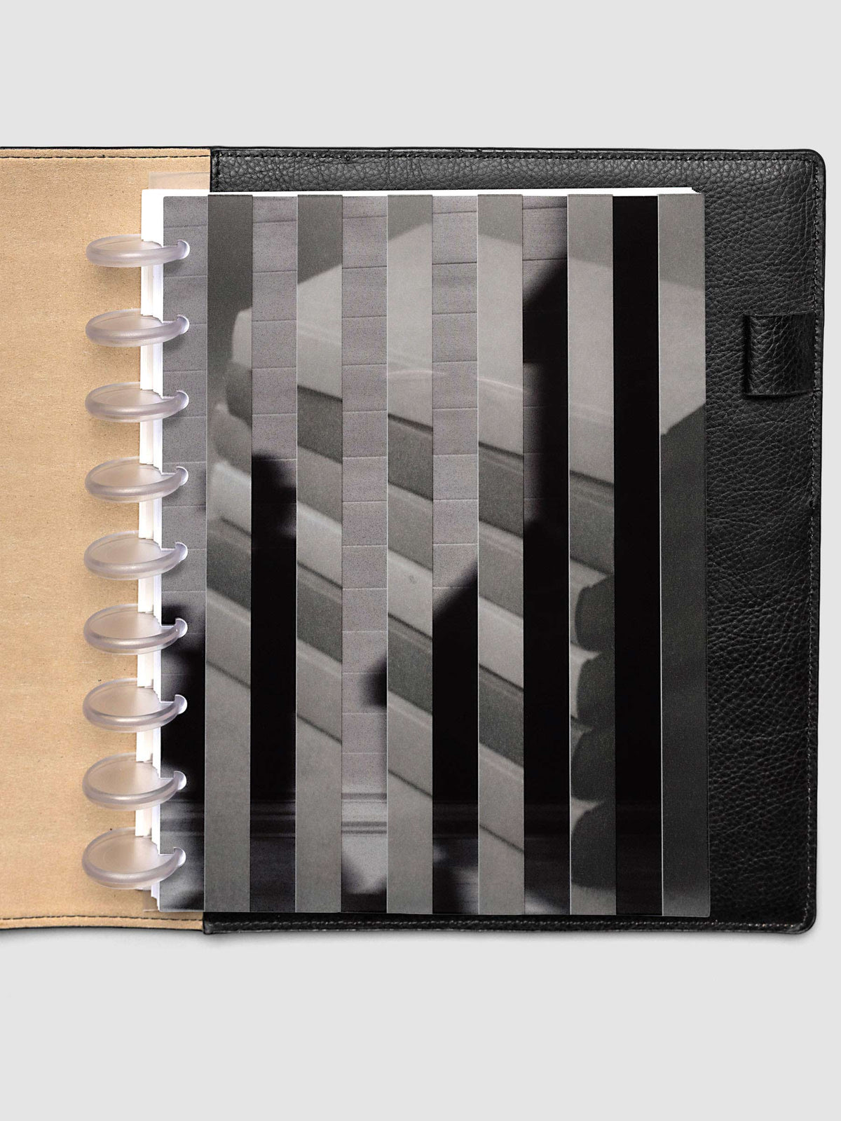The HP Classic 9-Disc Punch Strips Planner Dashboard Duo layered at the front of a black leather ring bound planner, both images combining into one striped picture