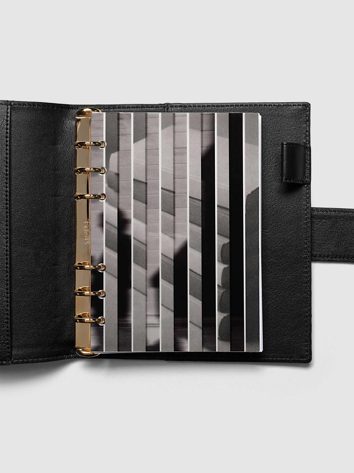 The Personal Wide Strips Planner Dashboard Duo layered at the front of a black leather ring bound planner, both images combining into one striped picture