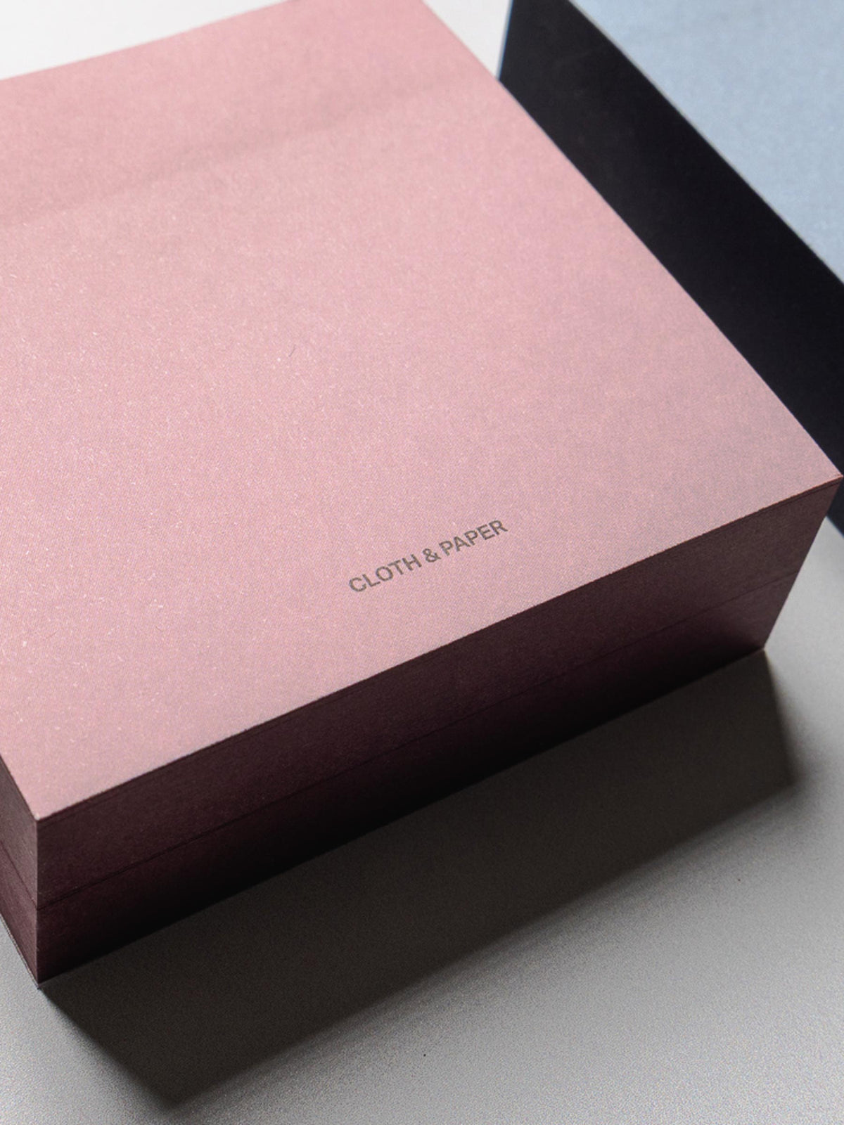 Close up of the Colorblock Sticky Note Set in pink/red showing the Cloth & Paper logo in small text at the bottom of the sticky note.