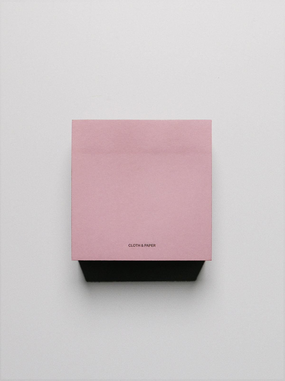 Block of pink/red colorblock sticky notes.